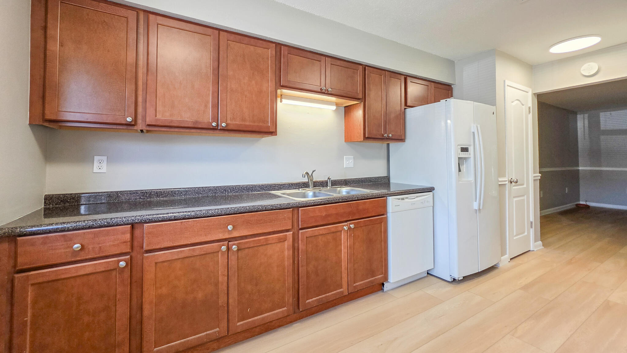 Freshly updated townhome, this 3-bedroom 2-bathroom features NEW VINYL FLOORING AND A FRESHLY PAINTED INTERIOR. The kitchen blends modern updates with easy, livable layout that features beautiful wooden cabinetry and generously sized countertops, while also having a convenient dual pantry hallway. Flowing directly into the living area, the home offers generous living space, with additional storage space. The second floor layout holds the primary bedroom with exceptional space, featuring the primary bath, perfect for privacy and convenience. The additional bedrooms , generously-sized, featuring a beautifully redone full bathroom, providing fresh, modern finishes. This refreshed townhome offers a fully fenced backyard, for added privacy, and a convenient exterior utility closet for extra storage. The inviting community pool is just feet away, offering the perfect extension of outdoor living.