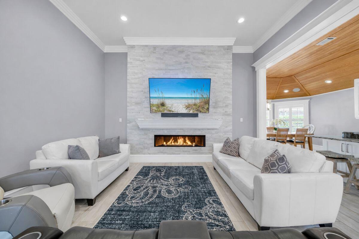 Tech-Forward Coastal Retreat With Private Beach Access--Remodeled in 2020 with an extraordinary level of finish and craftsmanship, this home presents a rare take on coastal luxury- sophisticated in design, effortless in function and remarkably livable on a single level. From the moment you enter, soaring ceilings, a hand-hewn marble stacked stone gas fireplace, reversed cake-tiered crown molding and carefully selected designer lighting set a striking tone. The open floor plan lives larger than its 2,200 square feet, enhanced by long-plank porcelain wood-look tile and seamless sightlines through the main living spaces. At the heart of the home, the kitchen pairs artistry with utility. Floating cabinetry with undermount lighting, quartz counters and backsplash and intricate custom cabinetry create a space that feels both polished and distinctive. Hand-hewn Florida cypress adds warmth and character, carrying through the home in a way that feels richly architectural rather than merely decorative. Full app integration and Sonos surround sound throughout the interior and exterior add a modern layer of convenience, allowing lighting and audio to be adjusted with ease. The primary suite is especially memorable, framed by vaulted Florida cypress ceilings and anchored by a spa-like bath with marble flooring, floating cabinetry, undermount lighting, dual vanities and an open walk-in shower. The custom rain showerhead, fabricated in Germany, adds another thoughtful detail. A walk-in closet with built-in cabinetry and automated lighting continues the home's tailored, tech-forward sensibility. A private guest wing is separated by a solid cypress barn door and offers exceptional flexibility. Two additional bedrooms each feature ensuite baths, Florida cypress ceilings and closets with automated lighting. One of these rooms can easily serve as a second primary suite thanks to its deep soaking tub with armrests, walk-in shower and three separate shower heads, including another custom German-fabricated rain showerhead. Throughout the baths, floating cabinetry, quartz countertops and custom tilework reinforce the home's consistent attention to detail. Practical spaces were given the same level of care. The spacious laundry room includes quartz countertops, extensive built-in cabinetry, shoe storage and motion-activated lighting. The attached two-car garage adds convenience, while smart security features include a front door that automatically locks when left unsecured and a garage door that closes on its own after an hour. Outdoors, a generator, hurricane shutters, and an irrigation system that delivers water directly to individual plants' roots for a more efficient approach to landscape care.  Set within Avalon Beach Estates along Scenic Highway 98, this residence also enjoys access to an impressive collection of neighborhood amenities, including Deeded Gated Beach Access, a heated swimming pool, tennis courts, pickleball courts, park areas, basketball and a quiet no-through-traffic setting. Dining along Scenic Highway 98, Destin Commons, beachside favorites including The Crab Trap, Captain Dave's and Pompano Joe's, plus a variety of shopping and entertainment options are all just minutes away. Equal parts refined and relaxed, this is a home that brings together craftsmanship, comfort and coastal convenience in a truly uncommon way.