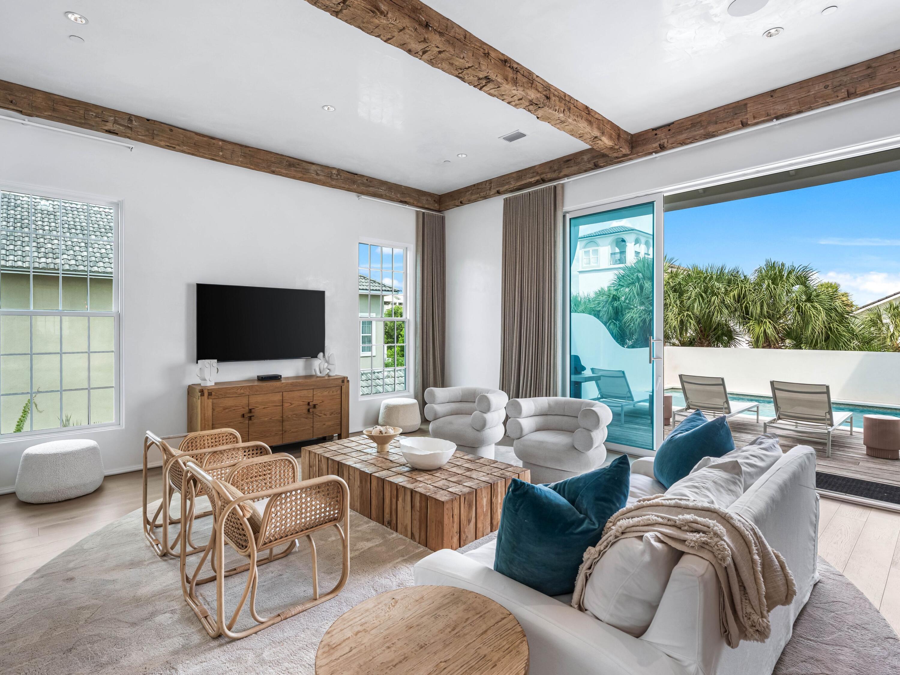 Welcome to Santimo Beach, where this 5,976 square-foot residence is among 20 exclusive properties inside the gated community.  Including dedicated beach access and built by the prestigious Benecki Homes with interiors curated by Melanie Turner this spectacular property has it all. The home's three elevator-accessible floors accommodate five bedrooms, a bunk room, five full bathrooms, and a powder bath. A staircase connects the third level to the tower, which offers panoramic views of the Gulf. Two king-size bedrooms, one with an ensuite bathroom, along with a bunk room, separate a guest bathroom, and a laundry room join an oversized two-car garage with a Tesla charging station on the ground floor. The emphasis on indoor-to-outdoor living is evident once you walk upstairs, where an open-concept living area connects to an elevated deck featuring chaise lounges and a heated pool.  Accordion windows fully retract at the outdoor bar, creating a pass-through between the pool deck and a casual dining area with a wet bar. Designer cabinets conceal a range of gourmet kitchen appliances, including a Liebherr refrigerator, Thermador freezer, and Asko dishwasher. Luxurious marble accents and a custom vent hood highlight the Wolf range. A waterfall countertop serves as a striking centerpiece on the kitchen island, with bar seating that transitions to an additional dining space.
The nearby scullery neatly contains another Asko dishwasher, beverage center and wet bar. The second floor with the powder bath, a media room and a double queen-size ensuite bedroom. An additional living area on the third floor creates a total of three distinct living spaces for owners and their guests to enjoy. The grande primary suite includes a luxurious bath retreat featuring a walk-in shower and soaking tub plus spacious closet.  A separate light-filled room is the perfect spot for an office or yoga studio. An additional king-size ensuite plus the second laundry room complete this level. This residence boasts multiple living areas, a pool deck meticulously designed for entertaining, elegantly appointed bedrooms, and a prime location within one of the most secluded gulf-front enclaves on 30A. Within its vicinity, you can enjoy both grandeur and functionality, conveniently situated just a short distance from the pristine beach. Santimo Beach is a gulf-front community that is surrounded by the vibrant new urbanism communities of Rosemary Beach and Alys Beach. This gated retreat provides its residents with an unparalleled level of privacy amidst the vibrant social scene that permeates the nearby town centers. These town centers offer a diverse array of shops, restaurants, and events, catering to the diverse interests of their residents.