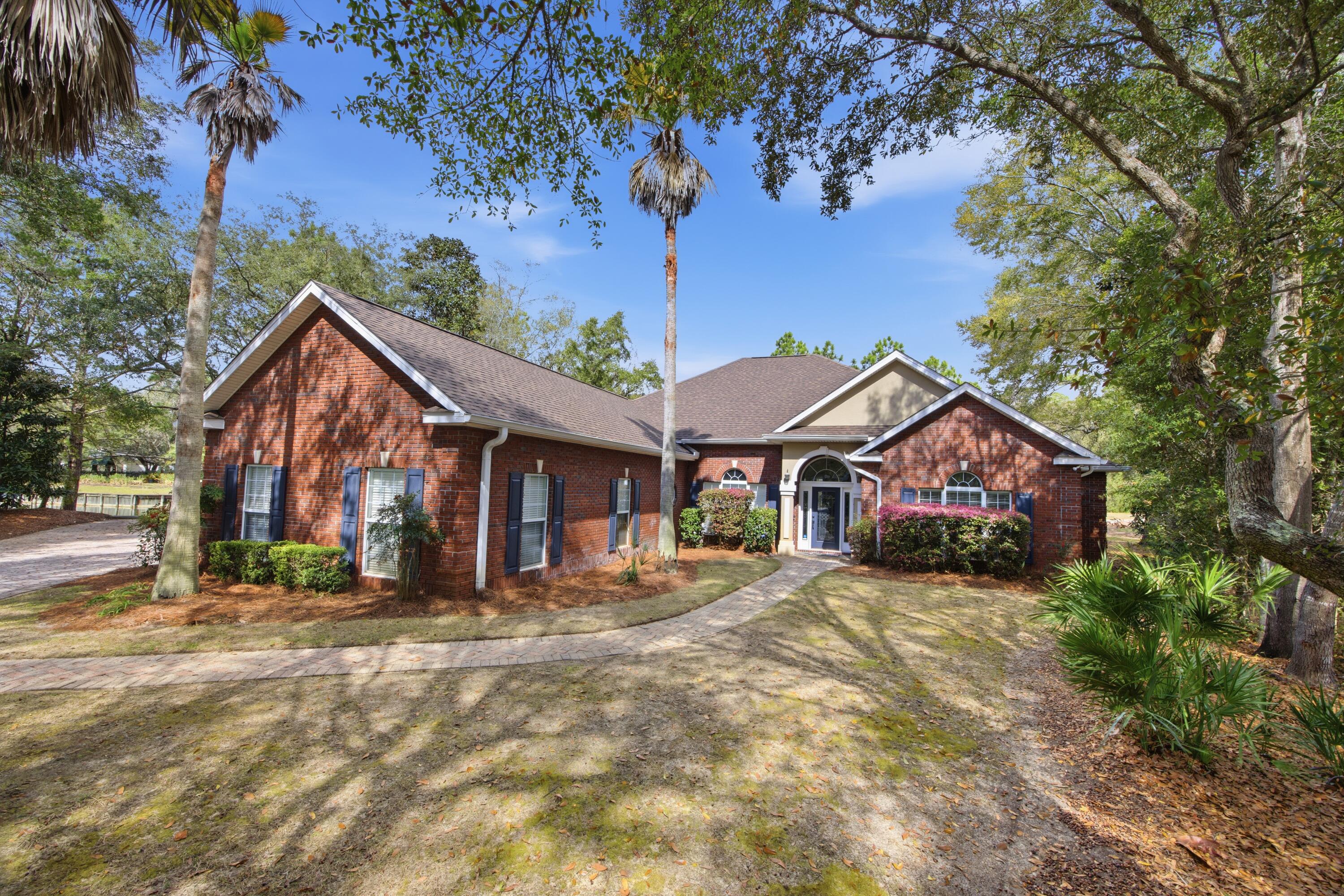 THIS HOME IS UNDER CONTRACT WITH 72 HR KICK OUT CLAUSE Beautiful CUSTOM BUILT and newly painted brick home, lakefront on a quiet cul-de-sac in GATED Magnolia Plantation in gorgeous Bluewater Bay! Spacious open floor plan offers four bedrooms, three full and one half bathrooms, large versatile formal dining room, inclosed sun room, side entry two car garage with new bluetooth garage door motor. Outdoor highllights include a screen enclosured patio with natural gas heated saltwater POOL/SPA and brand new pool pump. Heats easily in the winter for affordable year round use! For ease of mind, home has a NEW ROOF with new gutters including leaf guards as well as clear polycarbonate hurricane shutters. Inside features include hardwood floors, raised tray ceilings, granite counters, walk-in BULTER'S pantry, generously sized master suite with two walk in closets, jetted tub, walk in shower, dual vanities, private water closet. Front guest bedroom with ensuite bath could also be a mother-in-law suite or office. Two additional bedrooms with Jack and Jill bathroom. New water heater in 2025. HVAC updated with infrared HALO light. Great location close to bases, schools, and shopping. Just a short drive to the bridge, beaches, attractions, shopping, and restaurants in Destin. Luxury 6 person golf cart is negotiable. All dimensions should be verified.
