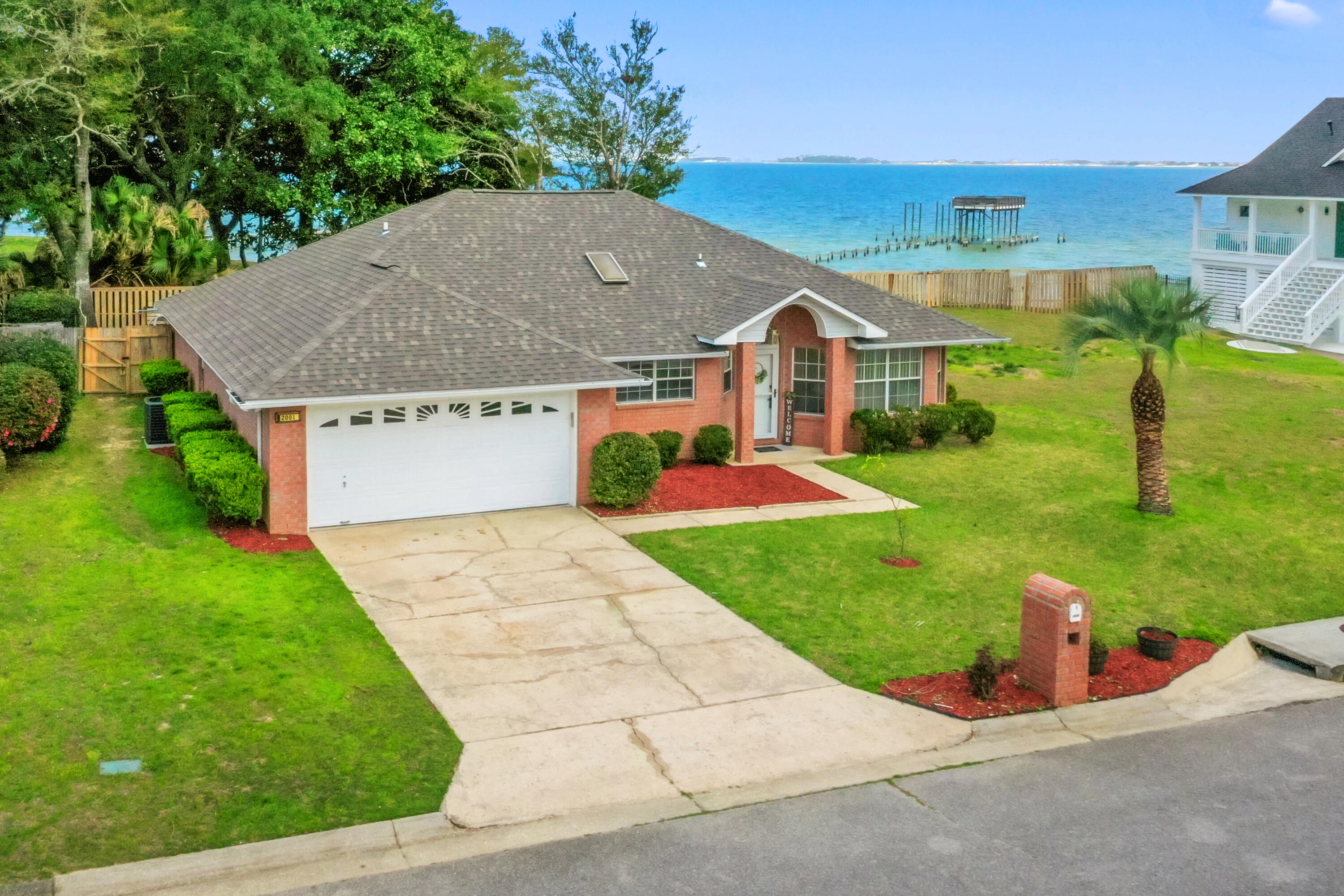 Recently Remodeled with a POOL and WATER VIEWS!!!!! Located in one of Navarre's most desirable waterfront-access communities, this beautifully updated 3-bedroom, 2-bath home offers deeded access to the Santa Rosa Sound and a private community pier. Enjoy paddle boarding, fishing, or simply taking in the peaceful water views, all just moments from your front door.
Inside, the home features an open layout with vaulted ceilings and skylights that bring in abundant natural light. The living area is anchored by a wood-burning fireplace and overlooks the backyard pool, creating a comfortable and inviting main gathering space.
The kitchen offers generous granite countertop space, a functional island, stainless steel appliances, and ample cabinetry. The primary suite is spacious and includes dual granite-topped vanities, and a soaking tub.
Outdoor living is a standout feature. The 168-square-foot enclosed patio provides additional flexible space for relaxing or entertaining. The backyard includes a private in-ground pool, plenty of yard space for play or lounging, and an elevated deck offering views of the Intracoastal Waterway.
Recent improvements include a brand-new roof (2026), new HVAC system (2025), new flooring throughout, fresh interior paint including walls, doors, and new trim, newly painted kitchen cabinets, granite countertops, updated sinks, new faucets and shower-heads, newly tiled around shower surrounds, new toilets, new light fixtures and switches, new door hardware throughout, fresh landscaping, and a new pool pump.
Conveniently located near beaches, dining, airports and Hurlburt and Eglin AFB.
Move-in ready and thoughtfully updated, this property offers a combination of amazing water views, community water access, outdoor living, and modern upgrades in a prime Navarre location. Schedule your private showing today to this one-of-a-kind home.