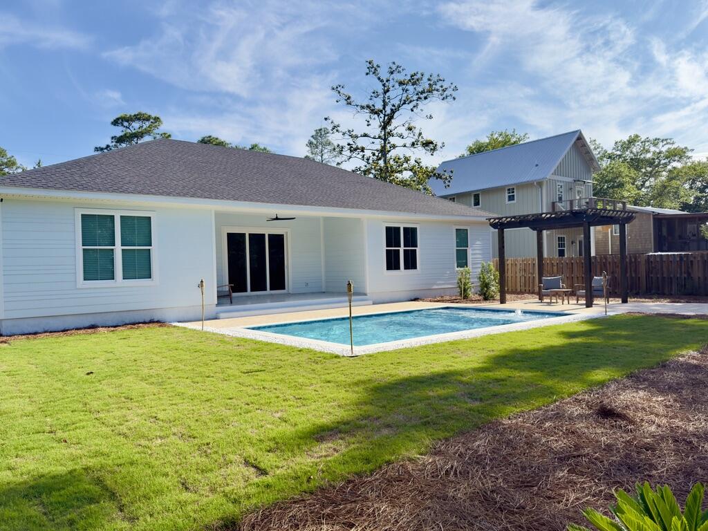 Completed in 2024 and ideally located just north of Hwy 98 with easy access to 30A West, this 4BR/2BA home sits on a spacious ~0.31-acre lot with no rental restrictions. The newly finished backyard offers a private retreat with a pool, paver deck, pergola, and thoughtful landscaping. Inside, the home features 10-foot ceilings, tile flooring, crown molding, and custom trim throughout. A wide three-panel sliding door fills the living area with natural light and opens to the backyard. The primary suite includes a soaking tub, a walk-in shower with a rain head, and a custom closet. Fully fenced with irrigation and a paver driveway. Located ~1.2 miles to Bay Circle Boat Ramp and ~3.5 miles to beach access.
