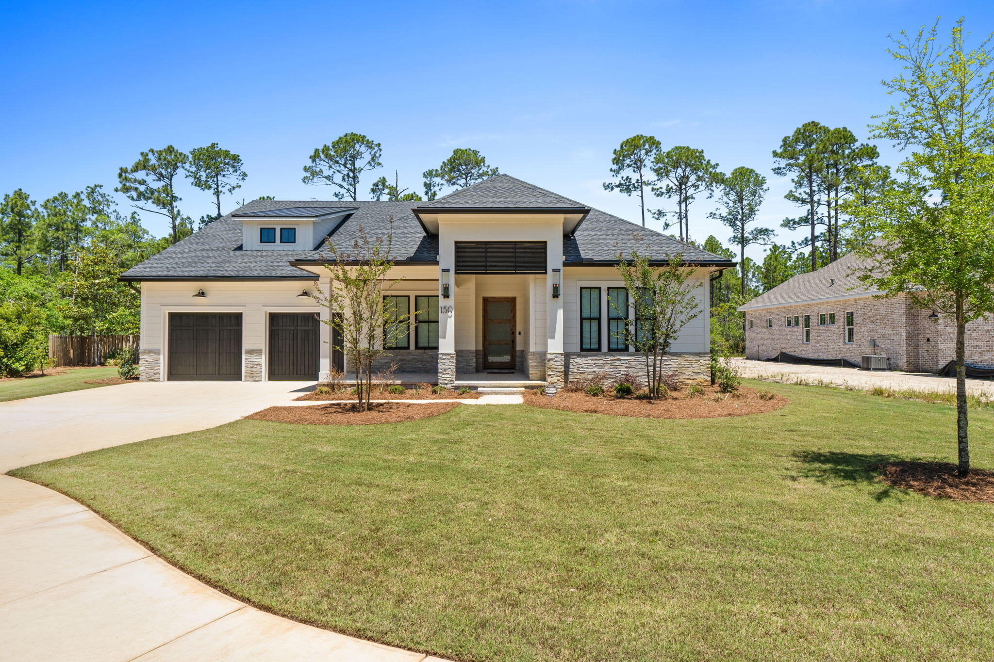 Stunning Randy Wise custom-built 4 bedroom, 3 bath home sits on spacious 1/3-acre private fenced lot on quiet cul-de-sac. This dream home backs to 120 acre nature preserve in the highly desirable Steamboat Landing at Hammock Bay. Offering 10ft ceilings, 8ft doors, and an abundance of premium upgrades, this lightly occupied part-time residence (since August 2025) shows like new with all warranties still in effect.Step inside the striking 42'' custom wood & glass front door with wireless keypad and Ring doorbell. Engineered hardwoods flow throughout the home, complemented by custom wood shades and curated lighting fixtures throughout. The gourmet kitchen boasts a Wolf range, modern hood, microwave, oversized refrigerator/freezer, walk-in pantry with ice maker and beverage cooler, and a beautiful Kohler white apron sink. The oversized primary suite features shiplap accent walls, pendant lighting, a custom closet with laundry access, and an oversized primary bath with his-and-her vanities and a large zero-entry shower with multiple shower heads. All showers in the home are zero-entry. Additional highlights include a large family room with tiled fireplace, Sonos sound system, upgraded tile in all bathrooms, Rinnai tankless water heater, and WiFi-enabled security system and oversized garage and door. Outdoor living is exceptional: A large screened porch with shellstone tile & stacked stone gas fireplace opens to an outdoor kitchen complete with grill, hood, and sink. Enjoy evenings lounging in the outdoor living room and eating al fresco with beautiful Florida breezes. The oversized 2-car garage offers room for a golf cart and currently stores a 21ft boat with outboard motor. Additional features include epoxy-coated garage floor, keypad entry for garage doors with motion sensor lighting, pre-wired pool panel, pre-wired for generator, storage loft above garage, and a well for irrigation with water filtration system for iron removal. New washer and dryer are negotiable.

This home is a short walk to the Bayfront Clubhouse and 500' pier, and within ten minutes of two other amenity centers offering four swimming pools, fitness centers, court sports, brewery, Windmills Town Center, General Store and walking trails, all offering the perfect blend of luxury, privacy, and coastal Florida living in Steamboat Landing at Hammock Bay! Buyer to verify all information and dimensions important to them.