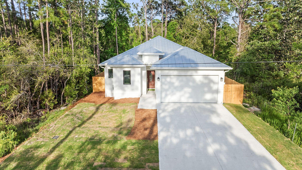 Are you looking for a brand new home in the desirable area of Santa Rosa Beach? Whether you're searching for a primary residence or a solid investment property with 'NO HOA' restrictions, this home is ready for you.

This brand-new home offers 1,880 square feet of heated and cooled living space, with a total building size of 2,435 square feet. It includes 4 bedrooms and 2.5 bathrooms and features a modern coastal design with an open-concept layout and high-quality finishes.

This home is built on a solid concrete slab foundation, providing stability and durability. It features 10-foot ceilings, quartz countertops, hardwood floors, stainless steel appliances, and abundant of natural light. The garage features a protective epoxy-coated floor, offering a long-lasting, low-maintenance surface, and provides ample space for a golf cart, equipment, or additional storage.

The fully fenced backyard provides privacy and a safe space for you and your beloved pets.

This home is a dream for outdoor enthusiasts, with plenty of activities nearby, including golf courses, hiking trails, and beautiful state parks. The Cessna Landing Boat Launch Park is less than half a mile away, and you're just minutes from multiple beach access points along 30A, perfect for enjoying the sugary beaches of the Emerald Coast.

Conveniently located near top-rated hospitals and medical centers, as well as fine dining, grocery stores, and shopping centers, everything you need is just a short distance away.

This home is completely move-in ready. Whether you're looking for beach living, rental income, or both, the choice is yours.
Call today to schedule your showing!