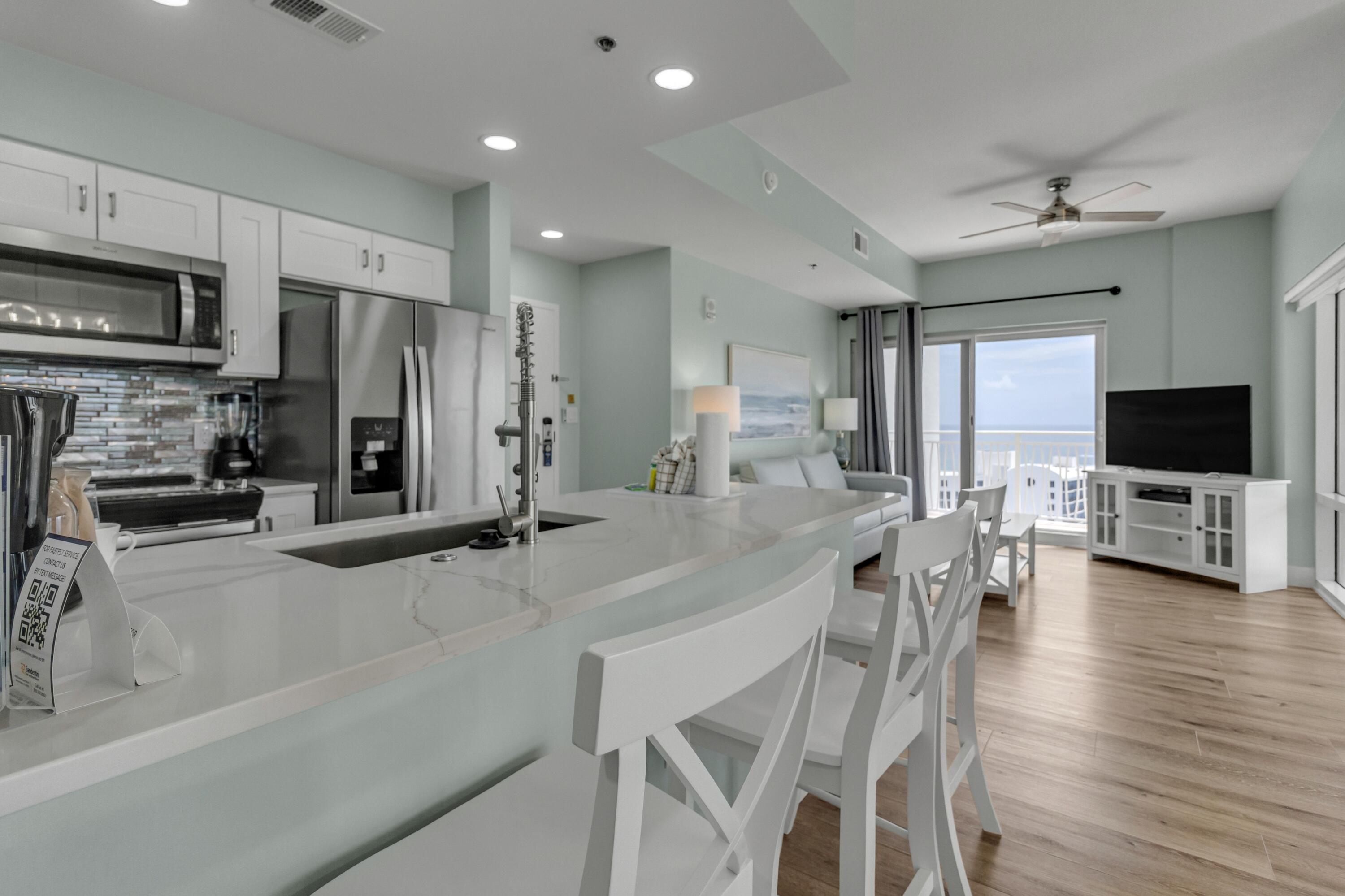 The flexible layout allows you to maximize rental yields by leasing them separately or together, sleeping up to 8 guests total.
The condo has been seamlessly renovated with fashionable furniture, updated flooring, new cabinetry, and premium countertops. Step out onto the expansive private wraparound balcony to enjoy breathtaking, unobstructed Northwest views of the Gulf of Mexico, the bay, and the resort golf course--perfect for taking in legendary Florida sunsets.

The 1-bedroom side offers a king suite, a queen sleeper sofa, a walk-in shower, and a full kitchen. The studio side features two queen beds, a full bath, and a convenient kitchenette. Situated just steps from the beach, Luau's lagoon pool, world-class golf, dining, and shopping at Sandestin, this high-ROI property is the perfect addition to your portfolio. Schedule your showing today! As an introduction to the Sandestin lifestyle, we invite our new owners to explore amenities that make Sandestin special. The listing brokerage and seller(s) are presenting the buyer(s) of this property with (2) 90-minute rounds of Tennis court time, a golf foursome at one of our three championship courses, and a round of golf for up to four (4) players at the unrivaled Burnt Pine Golf Club.

Sandestin Golf and Beach Resort features more than seven miles of beaches and pristine bay front, four championship golf courses, 15 world-class tennis courts, a 226-slip marina, a fitness center, spa and celebrity chef dining. Shop, dine and play at the charming pedestrian village, The Village of Baytowne Wharf and more. Inside the gates of the resort, residents enjoy a balanced lifestyle of high-class living, spanning the 2,400 acres from the beach to the bay. Everything within the gates of the resort is accessible by golf cart or bicycle. The entire resort is interconnected by miles of pedestrian, bike and golf cart paths that weave through groves of live oaks, meandering past natural lagoons, fountains, man-made lakes, and meticulously landscaped fairways.