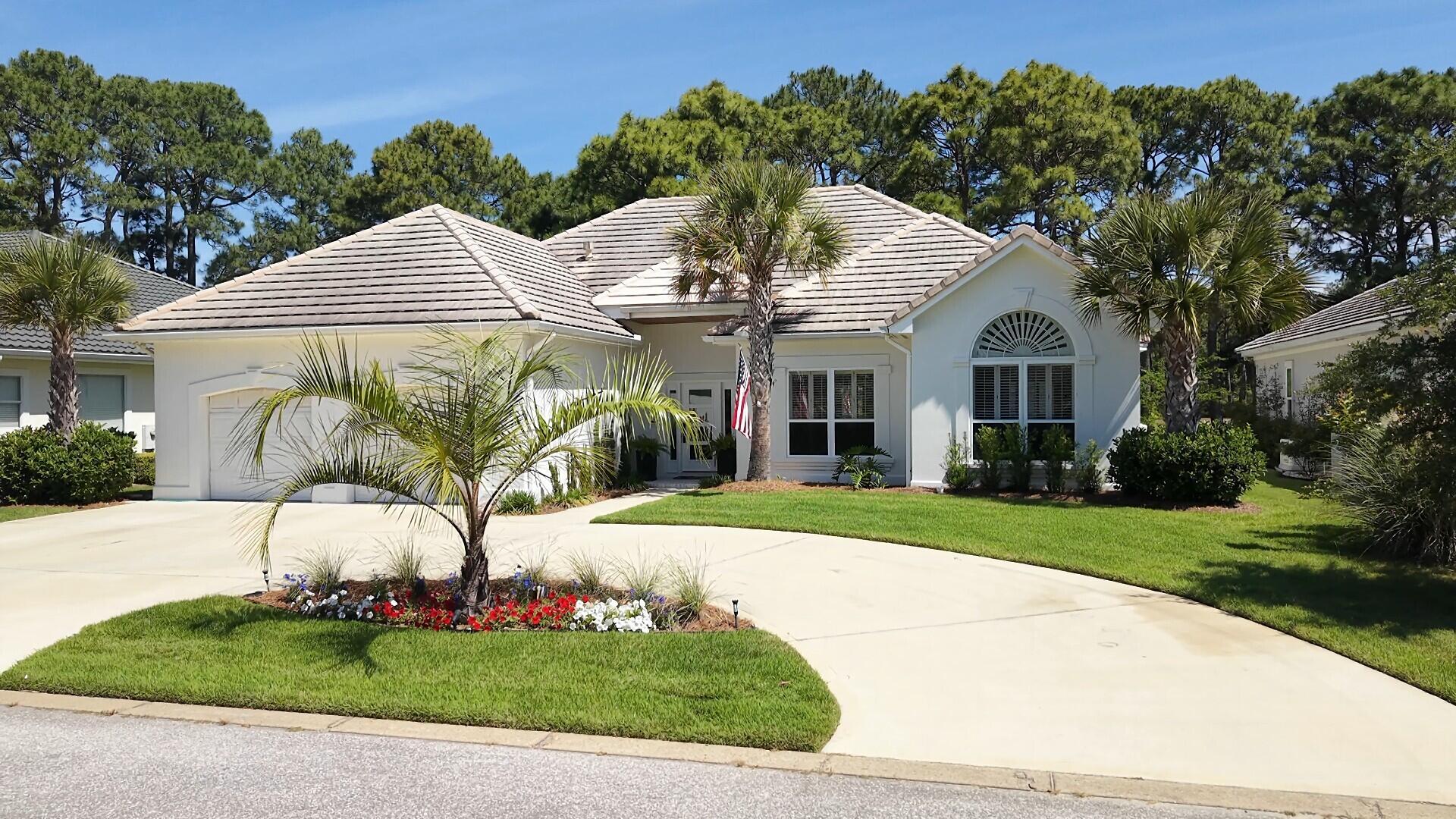 This impeccably designed 2227 sq. ft. single-story home offers 3 bedrooms, 2 bathrooms, and a dedicated office, blending coastal charm with elevated sophistication at every turn. Completed renovation in 2023. New HVAC system, new tankless gas water heater, and new attic insulation. New Lani screen showcases the newly landscaped yard. Wide-plank white oak floors flow seamlessly throughout, anchoring each sun-filled room in warmth and style. The grand living room captivates with soaring vaulted ceilings, a stunning fireplace flanked by custom built-ins, and French doors that spill natural light across the space. The fully renovated open kitchen-living area is a chef's dream -- featuring high-end kitchen appliances that includes: microwave drawer, refrigerator/freezer drawers, wine fridge,  gas range with custom hood, that is surrounded by an abundance of premium shaker cabinetry with brick tile backsplash and stunning quartz 'waterfall' countertops all beneath elegant arched architectural details. The primary suite is boasting a coffered ceiling, plantation shutters, and hardwood floors. The fully renovated ensuite is spa-inspired with dramatic marble-look tile, premium cabinetry, an arched window, walk-in soaking tub, and double vanity. Guest spaces are equally refined, with light-filled rooms and a beautifully appointed second bath with gold-accented fixtures. An in-home office adds versatile functionality. This is more than a home -- it's the Destin dream, perfectly lived.