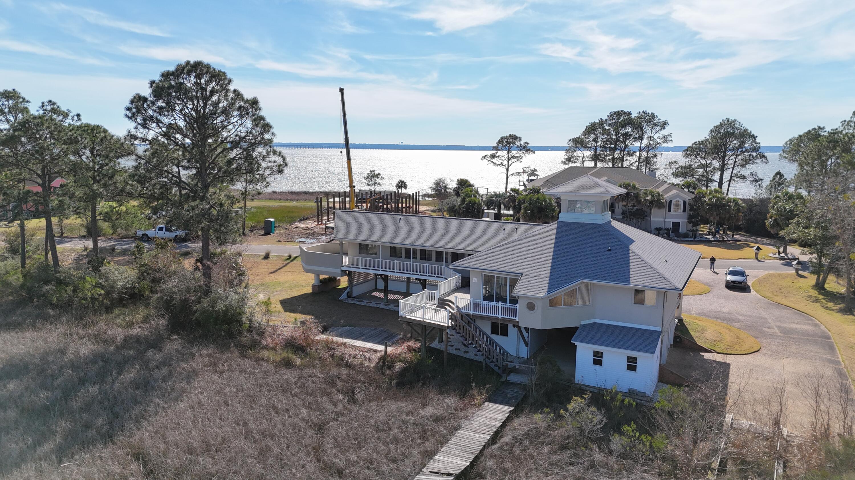 Waterfront living doesn't get better than this. From the moment you step outside, the bay becomes your backyard complete with a private dock,  and wide-open water views that make every day feel like a getaway. This is the kind of property buyers wait years for, and opportunities like this don't come around often. Inside, this 3-bedroom, 3-bath home offers a comfortable layout with bright living spaces designed to capture the scenery outside. Large windows bring in natural light and frame the water from multiple rooms, while the flow of the home works equally well for everyday living or hosting guests. Each bedroom provides privacy and flexibility for family or visitors. Outdoors is where this home truly shines. Conveniently located near dining, shopping, and beaches, this home delivers the full Florida waterfront lifestyle. Please note: Dock has been damaged from hurricane Sandy and will be sold AS-IS