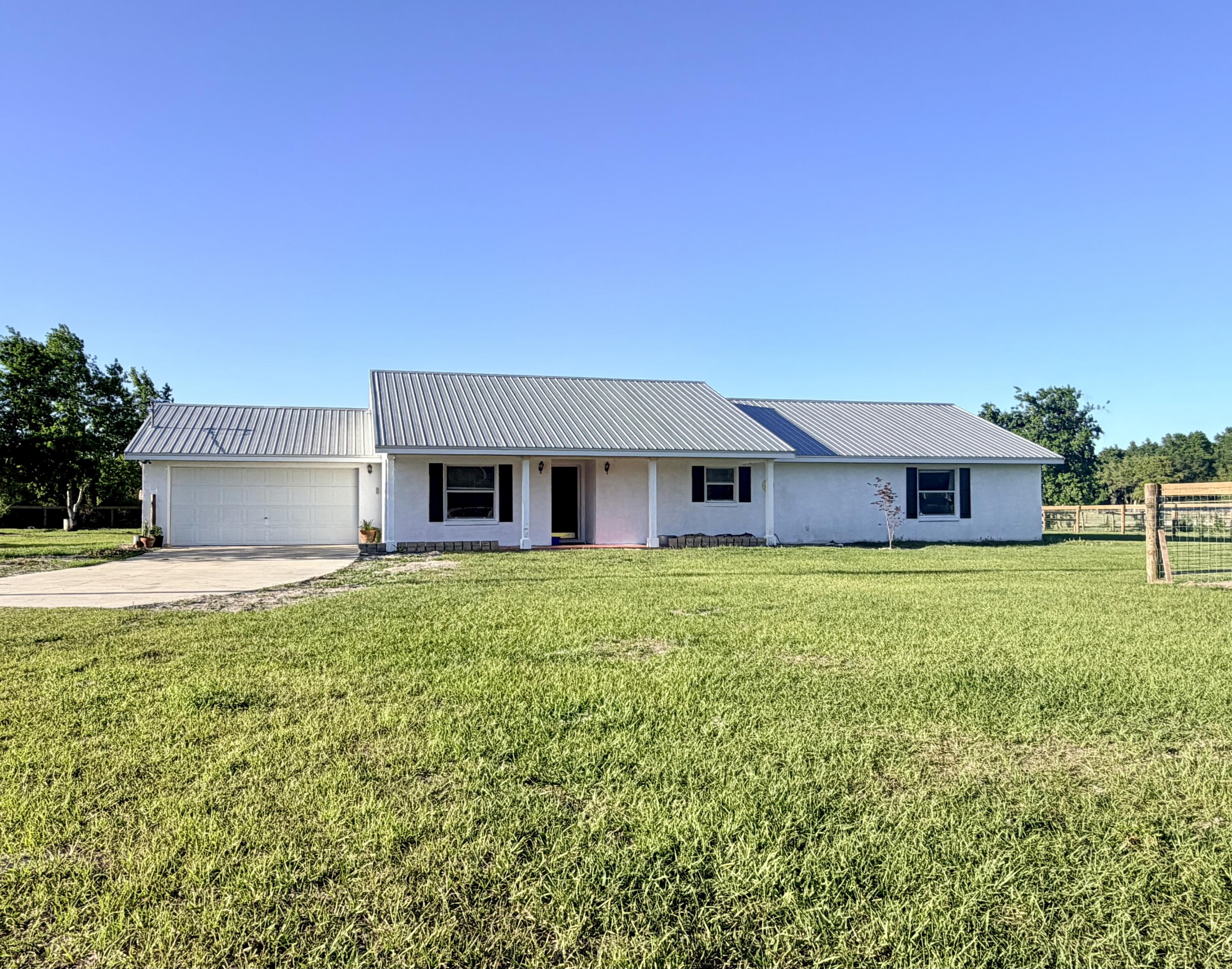 Five fenced acres with gated entrance and open pasture in Sumter County, FL - the kind of property that rarely comes up and never lasts. Come home to sunsets over your own land, with The Villages and Ocala just miles away. This 3Bed/2Bath block home has RENOVATION UNDERWAY with significant upgrades complete: new HVAC and fencing. The rest is yours to finish on your terms. Metal roof, perimeter fencing, AG zoned, no HOA. Minutes to dining, shopping and everything The Villages offers, then come back to your own open pasture. Ocala, the World Equestrian Center and Florida Horse Park all within easy reach. You will not find a site-built home on 5 fenced acres of high, dry, open pasture in this area at this price. Seller only accepting cash offers. Bring the horses and come home.