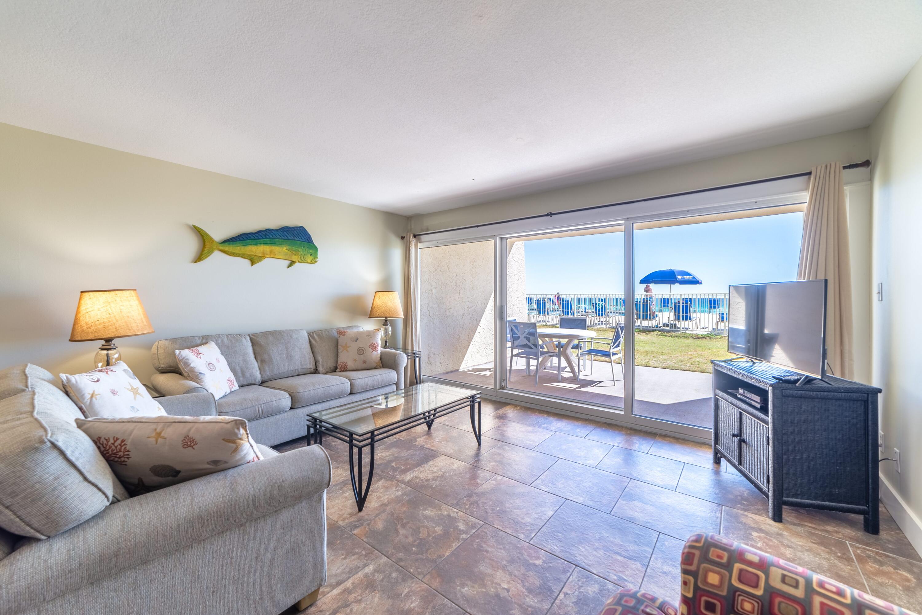 Step out of your condo and immerse yourself in the sights, sounds, and refreshing coastal air of the beach. This first-floor unit offers stunning views of  the pool, with the convenience of direct walk-out access with no elevators required. Featuring two bedrooms and two bathrooms, the condo comfortably accommodates up to seven guests, offering a spacious layout ideal for relaxing or entertaining. Enjoy outdoor living with access to BBQ grills, along with community amenities including an exercise room and pickleball courts. One of the standout features is the deeded access to 650 feet of pristine beachfront, perfect for unwinding just steps from your door. With the beach so close, it's easy to pop back inside for a quick snack or a midday nap. Located just minutes from shopping and dining, this community offers both convenience and coastal charm. Don't miss this rare opportunity to own a gulf-front condo at the Beach House. Contact us today for more information!