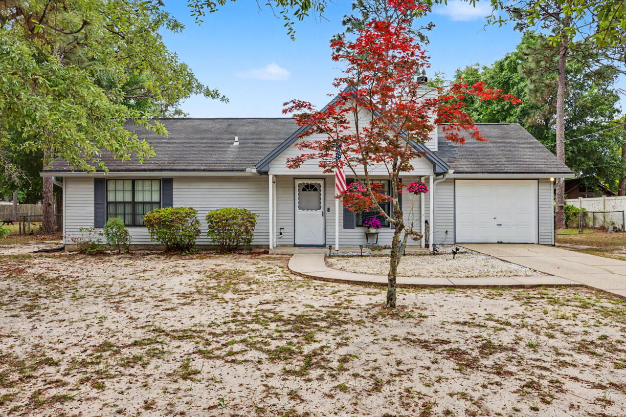 LOCATION, LOCATION, LOCATION! This home is perfectly located outside of city limits in South Crestview- allowing for a short commute! This quaint home sits on a open, flat parcel with an attached 1 car garage and a 10'x12' workshop with power! The fully fenced backyard is a relaxing place to spend your afternoons and weekends. Inside you will find an updated kitchen with newer appliances and fresh paint that overlooks the living room with fireplace and woodbeam ceiling. The primary bedroom has a walk-in closet and a separate entrance to the full bath. BRAND NEW carpet in all 3 bedrooms! The laundry area offers additional storage space as well. NEW ROOF AT CLOSING! This home is ready for you to move right in- schedule your showing today!