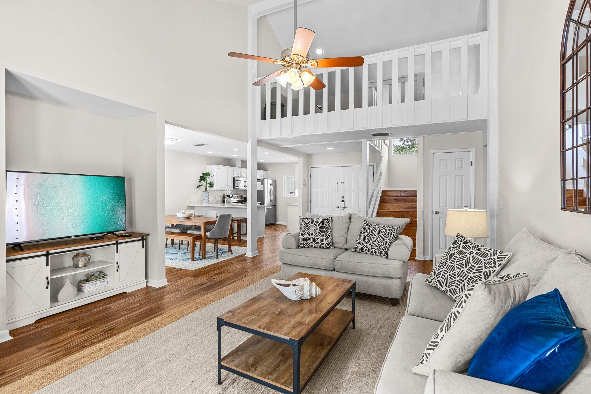 This stunning fully furnished home is located in Sandestin's Linkside Village among lush Florida landscaping. This unique floorplan has  one master suite upstairs and one downstairs. An additional guest bedroom, full bathroom, and loft complete with daybed provide spacious and comfortable accommodations. for you and your guests. Enjoy the privacy of the FULLY fenced yard, the upstairs master suite's balcony  or the patio off the living area. This home just just around the corner from the new community pool and would be a wonderful primary address, 2nd home or vacation rental Sandestin Golf and Beach Resort features more than seven miles of beaches and pristine bay front, four championship golf courses, 15 world-class tennis courts, pickleball courts, 108 catch and release ponds stocked with bass (no fishing license required), a 226-slip marina, a fitness center, spa and celebrity chef dining. Shop, dine and play at the charming pedestrian village, The Village of Baytowne Wharf and more. Inside the gates of the resort, residents of the 72 distinctly different neighborhoods enjoy a balanced lifestyle of high-class living, spanning 2,400 acres from the beach to the bay. There are just over 4600 properties within the gates which offer 24 hrs./day gated security. Everything within the gates of the resort is accessible by golf cart or bicycle. The entire resort is interconnected by miles of pedestrian, bike and golf cart paths that weave through groves of live oaks, meandering past natural lagoons, fountains, man-made lakes, and meticulously landscaped fairways.
Just beyond the gates, Grand Blvd with its weekly farmers market, varied events and superb section of dining and shopping is readily accessible by golf cart. The Market Shops, on the south side of highway 98, boasting more dining and shopping choices, is easily accessible utilizing the tunnel beneath Hwy 98