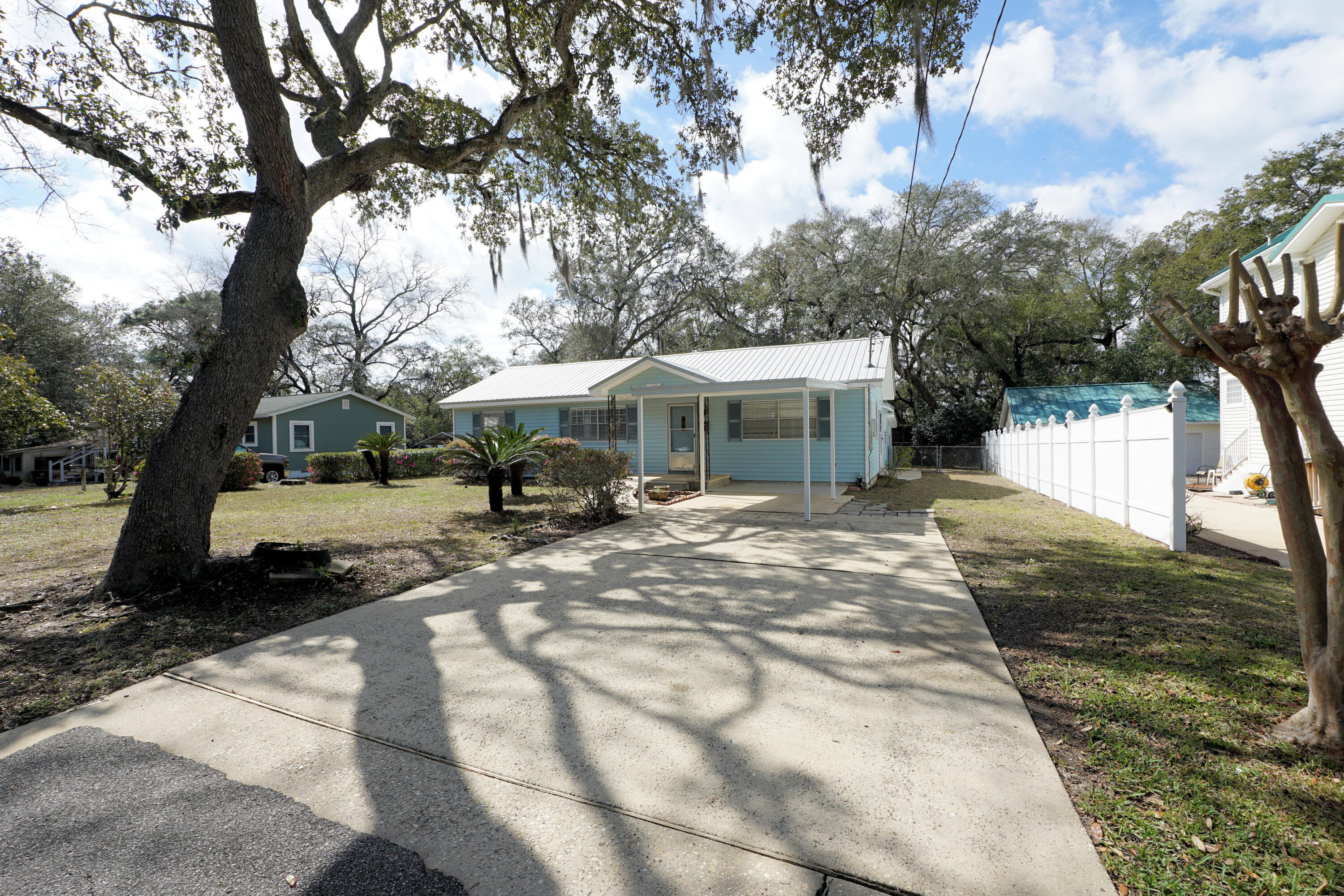 Cute Florida cottage tucked away on a quiet cul-de-sac in Valparaiso, just minutes from Eglin Air Force Base.
This charming home offers a split floor plan with three bedrooms and two bathrooms. The hall bath has been tastefully updated with a new vanity, mirror, and lighting. The kitchen features shaker-style cabinetry, an island for additional prep space, and beautiful butcher block countertops.
You'll appreciate the abundance of storage, including a large bonus storage room that could easily serve as a home gym, playroom, or hobby space.
Outside, the fenced backyard includes a storage shed and plenty of room to relax or entertain. The property also offers a covered carport and mature landscaping, highlighted by blooming azaleas and camellias, along with a fig tree and sago enhance the classic Florida cottage feel.
AC replaced in 2020
Roof in 2013
Kitchen in 2025
Hall bath in 2025
Water Heater - 2005