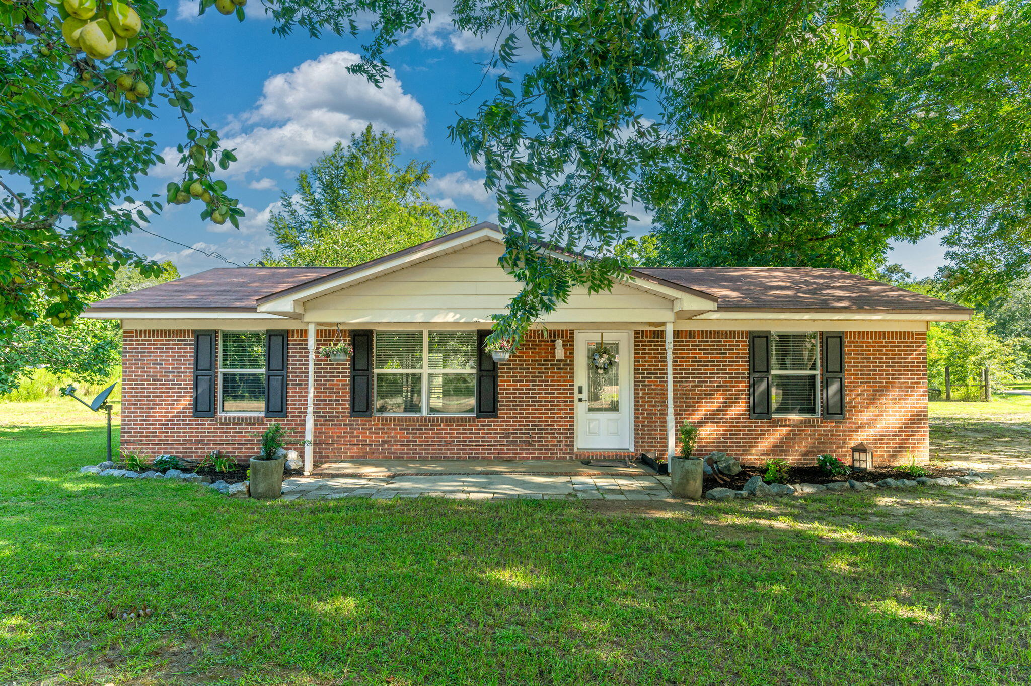 Fish Pond, Fruit Trees, Pecan Trees & more - Beautifully maintained 3 bedroom, 2 bathroom brick home located in the peaceful community of Glendale, Florida. Sale includes 4 LOTS that could be left together or split!! This property offers the perfect blend of comfort and outdoor living on a spacious property that includes access to a stocked pond (bream & bass), three varieties of producing pecan trees, a pear tree, and a fig tree, The parcel with the home includes 2 lots and there's 2 additional lots included as well. Inside, the home features tile flooring throughout the main living areas and bathrooms, with carpet in all 3 bedrooms. Fresh interior paint, updated windows, wood cabinets, and matching Whirlpool stainless steel appliances give the home a clean, updated feel. Enjoy the outdoors with a custom-built real wood cabana area complete with a concrete pad, rough-cut wood bench, with a TV mount and outdoor fireplace perfect for entertaining. Access easily by county-maintained roadways. Another plus? This property has a private well & septic system to help reduce your monthly utility bills. Don't miss out on this unique property offering comfort and country charm!