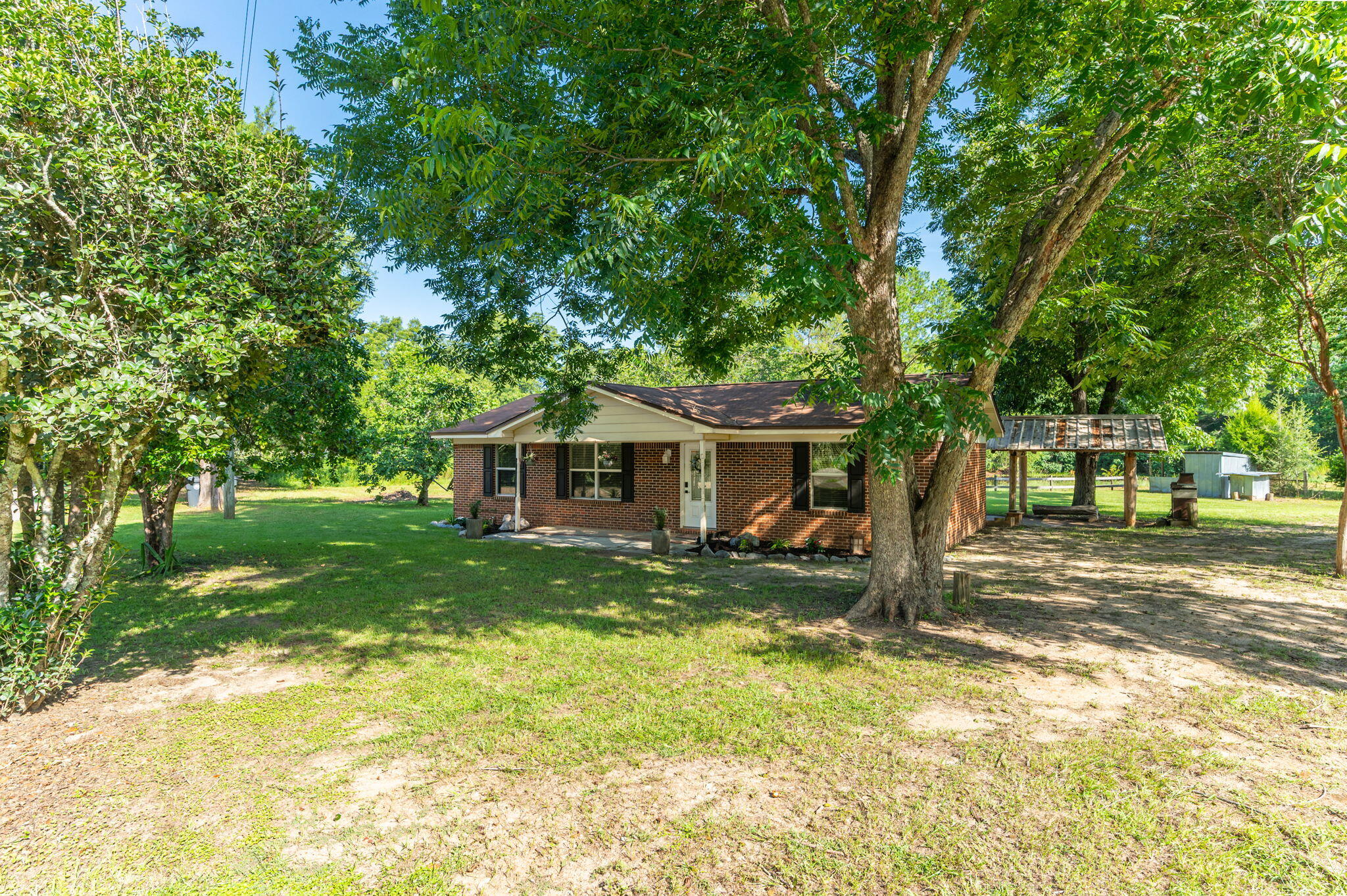 Fish Pond, Fruit Trees, Pecan Trees & more - Beautifully maintained 3 bedroom, 2 bathroom brick home located in the peaceful community of Glendale, Florida. Sale includes 4 LOTS that could be left together or split!! This property offers the perfect blend of comfort and outdoor living on a spacious property that includes access to a stocked pond (bream & bass), three varieties of producing pecan trees, a pear tree, and a fig tree, The parcel with the home includes 2 lots and there's 2 additional lots included as well. Inside, the home features tile flooring throughout the main living areas and bathrooms, with carpet in all 3 bedrooms. Fresh interior paint, updated windows, wood cabinets, and matching Whirlpool stainless steel appliances give the home a clean, updated feel. Enjoy the outdoors with a custom-built real wood cabana area complete with a concrete pad, rough-cut wood bench, with a TV mount and outdoor fireplace perfect for entertaining. Access easily by county-maintained roadways. Another plus? This property has a private well & septic system to help reduce your monthly utility bills. Don't miss out on this unique property offering comfort and country charm!