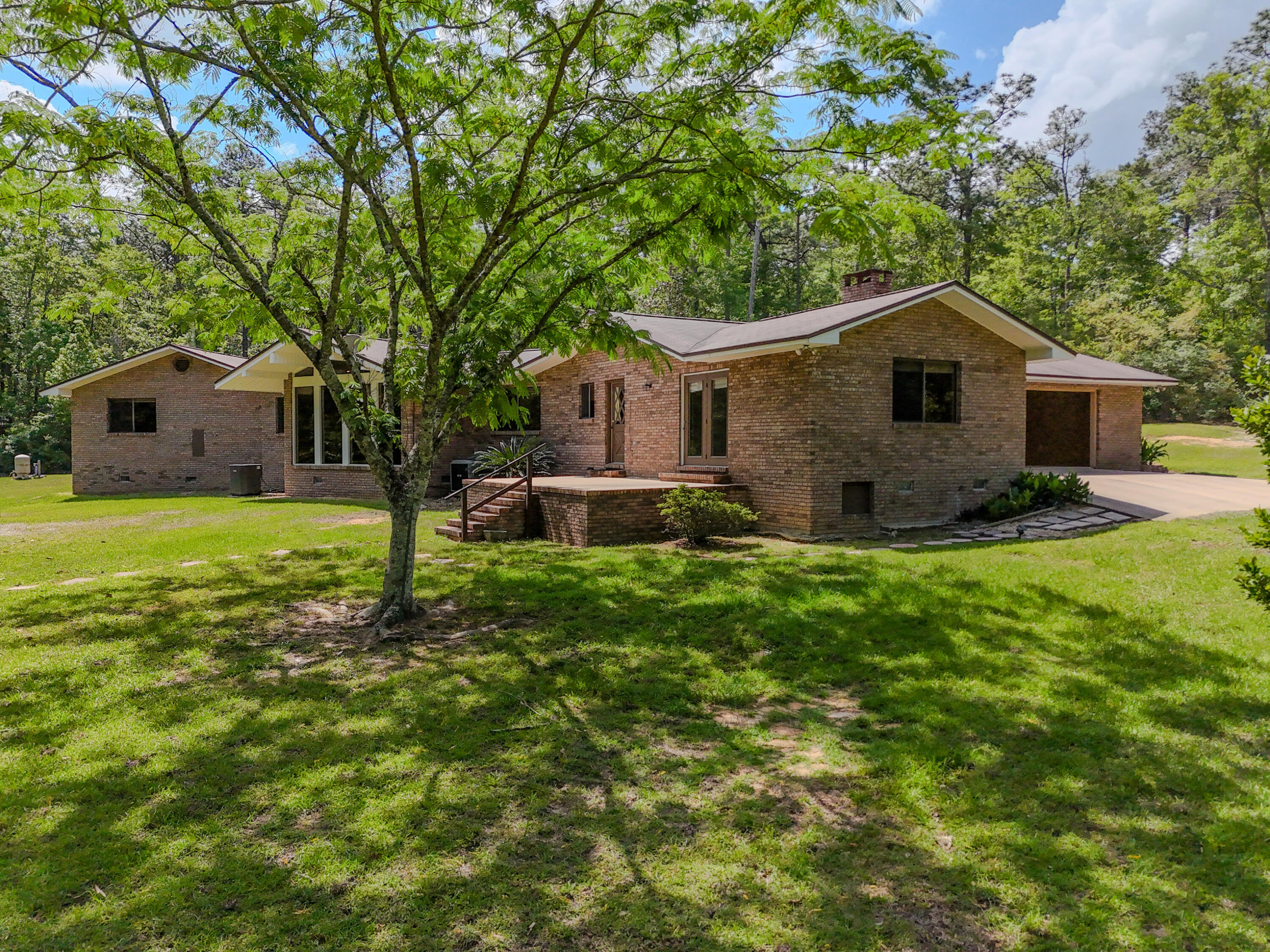 Tucked away on a generous 17.5-acre parcel, this charming 2,899 SF, 4-bedroom, 2.5-bath home.Step inside to discover a classic sunken living room, where oversized windows fill the space with natural light. Each bedroom offers ample space, while the 2.5 baths ensure convenience for both residents and guests.Enjoy the peaceful setting and being within walking distance to the scenic beauty of Falling Waters State Park-perfect for outdoor enthusiasts. Ideally located less than 10 minutes from Chipley Walmart, a variety of shopping options, and easy access to Interstate 10, this home offers both seclusion and convenience. Plus, you're less than an hour from the World's Most Beautiful Beaches in Panama City Beach, including the popular Pier Park shopping and entertainment district.