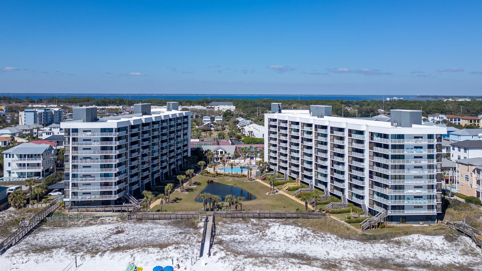 Amazing Rental Investment! Seller to pay $20,000 towards interest rate buy down with preferred lender.  Experience refined beachfront living in this extraordinary two-story Mainsail Gulf-view residence, where timeless coastal elegance meets effortless luxury along the Emerald Coast's world-renowned shoreline. Offering over 2,028 square feet of beautifully designed living space, this exceptional 3-bedroom, 3-bath retreat captures the essence of upscale coastal living with two private primary suites, dual balconies, and sweeping panoramic views of the Gulf's emerald waters and pristine sugar-white beaches.
The main living level welcomes you with dramatic cathedral ceilings and expansive windows that frame the Gulf like living art, filling the space with natural light and breathtaking scenery The open-concept design creates an inviting yet sophisticated atmosphere ideal for both quiet relaxation and elegant entertaining. The kitchen is thoughtfully arranged with a breakfast bar for casual gatherings, clean white finishes, and a conveniently located utility closet with washer and dryer for everyday ease.

The first-floor primary suite offers a tranquil private escape with direct balcony access, elegant mirrored detailing, and a beautifully tiled walk-in shower. Upstairs, the second primary suite features its own private balcony, providing a peaceful vantage point for morning coffee with coastal breezes or unforgettable sunset views over the water. A third bedroom with a private bath offers comfort and privacy for guests or extended stays.  There is a small sitting area outside the upstairs bedrooms for extra family entertaining.  

Tile flooring throughout the main living areas and classic crown molding enhance the refined coastal aesthetic, creating a residence that feels both polished and welcoming. Every detail reflects a lifestyle centered on comfort, beauty, and the effortless rhythm of beachfront living.

Positioned within one of the Emerald Coast's most sought-after resort communities, this residence offers an exceptional opportunity as a private coastal retreat, executive second home, or premier investment property just steps from the shoreline and moments from world-class dining, shopping, and recreation.

Presented by one of the nation's top luxury listing agents, this is a rare opportunity to secure a residence that embodies the very best of Emerald Coast living  where luxury, location, and lifestyle meet seamlessly along the Gulf.