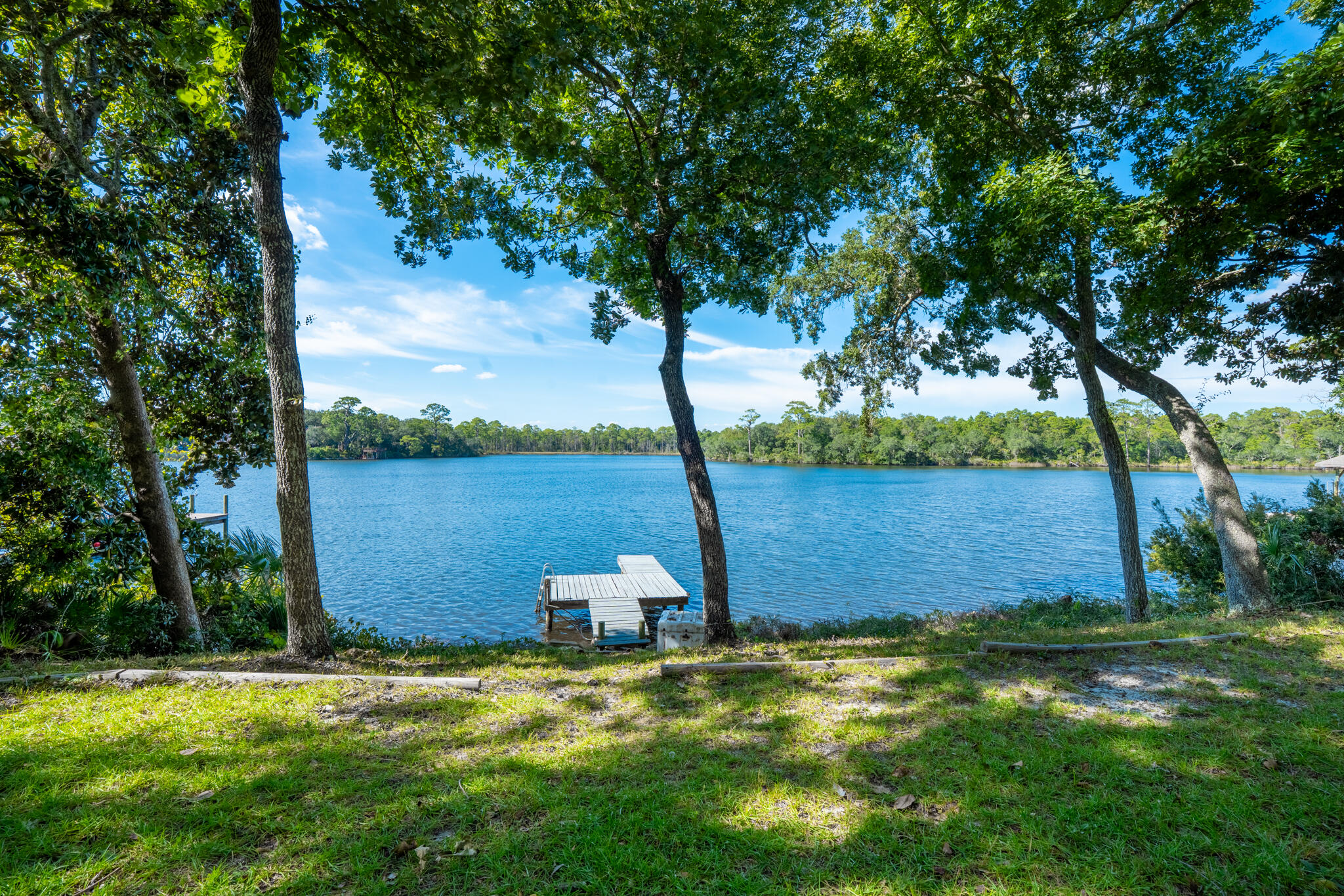 Experience the perfect blend of luxury, craftsmanship, and waterfront living in this fully renovated coastal retreat. Renovated from roof to floors this home offers peace of mind with no detail overlooked. On 130 feet of shoreline, the property features a water dock with direct boating access to the Intracoastal Waterway and the Gulf, cruising past Crab Island. The home itself sits at 18 feet of elevation, offering both stunning views and added security. High-end finishes define every space. Custom Amish-built cabinetry pairs beautifully with striking quartzite countertops, while rich oak flooring runs throughout the home. Every system has been upgraded, including a new roof, windows, HVAC, plumbing, and much of the electrical. This is a rare opportunity to own a turnkey waterfront property