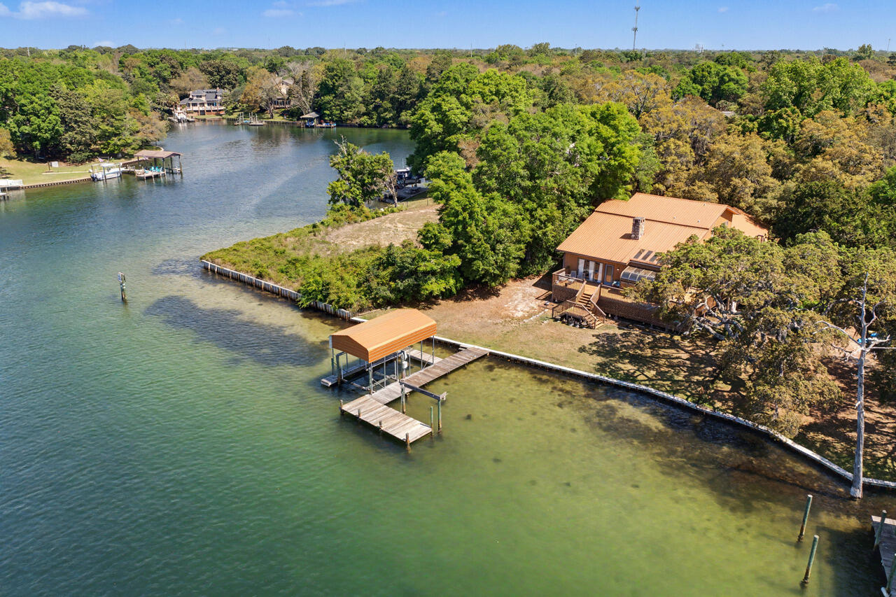Rare Waterfront Opportunity on Cinco Bayou - One Owner Home!



Don't miss this limited opportunity to own a one-owner waterfront home on beautiful Cinco Bayou, where you can enjoy serene views and even watch dolphins from your own backyard. Situated on a generous .32-acre lot, this property offers endless potential to create your dream coastal retreat.



This spacious home features 3 bedrooms, 3 full baths, and a 3-car garage, with a layout designed for both comfort and functionality. The great room makes a statement with soaring wood-paneled ceilings and walls, anchored by a stunning stone fireplace. The kitchen is generously sized with Corian countertops, a large island with JennAir downdraft range, custom wood cabinetry with pull-outs, and a bright breakfast nook overlooking the water The primary suite is conveniently located on the first floor and includes an oversized walk-in closet and direct access to two separate bathrooms and the hot tub screened porch.  Upstairs, you'll find two additional bedrooms, a full bath with double vanities, a spacious landing, and access to an upper deck offering panoramic bayou views.

Additional highlights include a durable metal roof, cedar siding, elevated construction (home has never flooded), two laundry areas, and abundant storage throughout. Relax year-round on the screened porch or take in the peaceful waterfront setting from multiple vantage points. Let's not forget about the covered dock, perfect for storing all of those recreational water sports toys. 

Speaking of boats...If you want to be where the action is, this property is a short boat ride to popular locations like,
5 minutes to Choctawhatchee Bay
10 minutes to Crab Island
12 minutes to Destin Harbor
15 minutes to East Pass

While the home could benefit from some updates, it presents a rare chance to customize a solid, well-built waterfront property in a highly desirable location.

Schedule your private showing today and explore the possibilities!