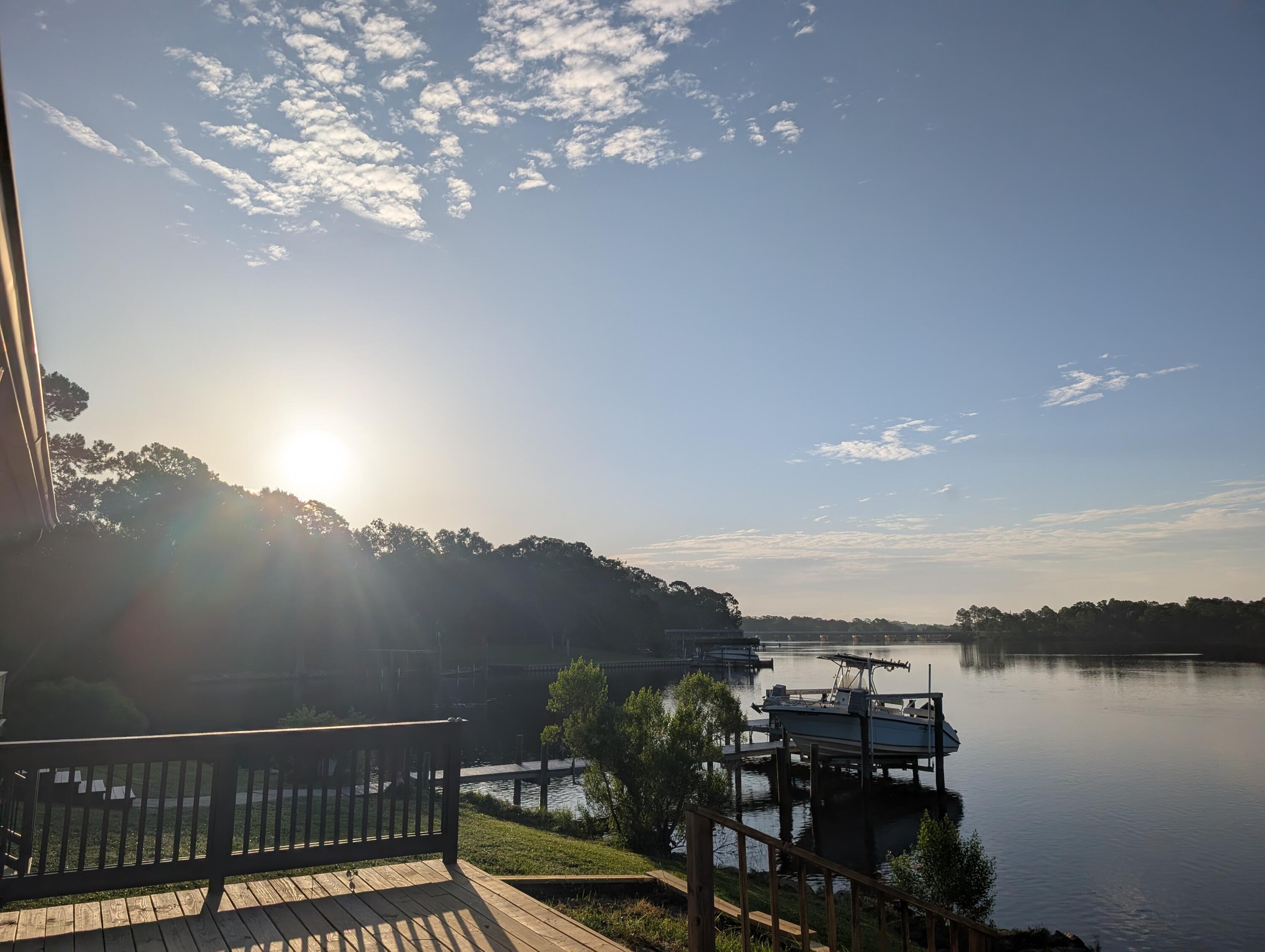 Waterfront community, convenient location! and despite ''hidden'', it is very convenient! Unit provides sunrise view of  osprey, dolphins and pelicans and Tom's Bayou from your bedroom and living room windows! Eglin AFB gate is 6 minutes away. The Hidden Cove club house, dock and pool are just a moment away! as yo. This awesome townhome features carpet and tile flooring, and LVP,  vaulted ceilings, washer and dryer hookups in garage, huge walk-in closets, remodeled master bath, large screened patio, and a huge, private deck not 20 feet from Tom's Bayou! Easy waterfront living, with landscaping provided. Call today, this home will go quickly!