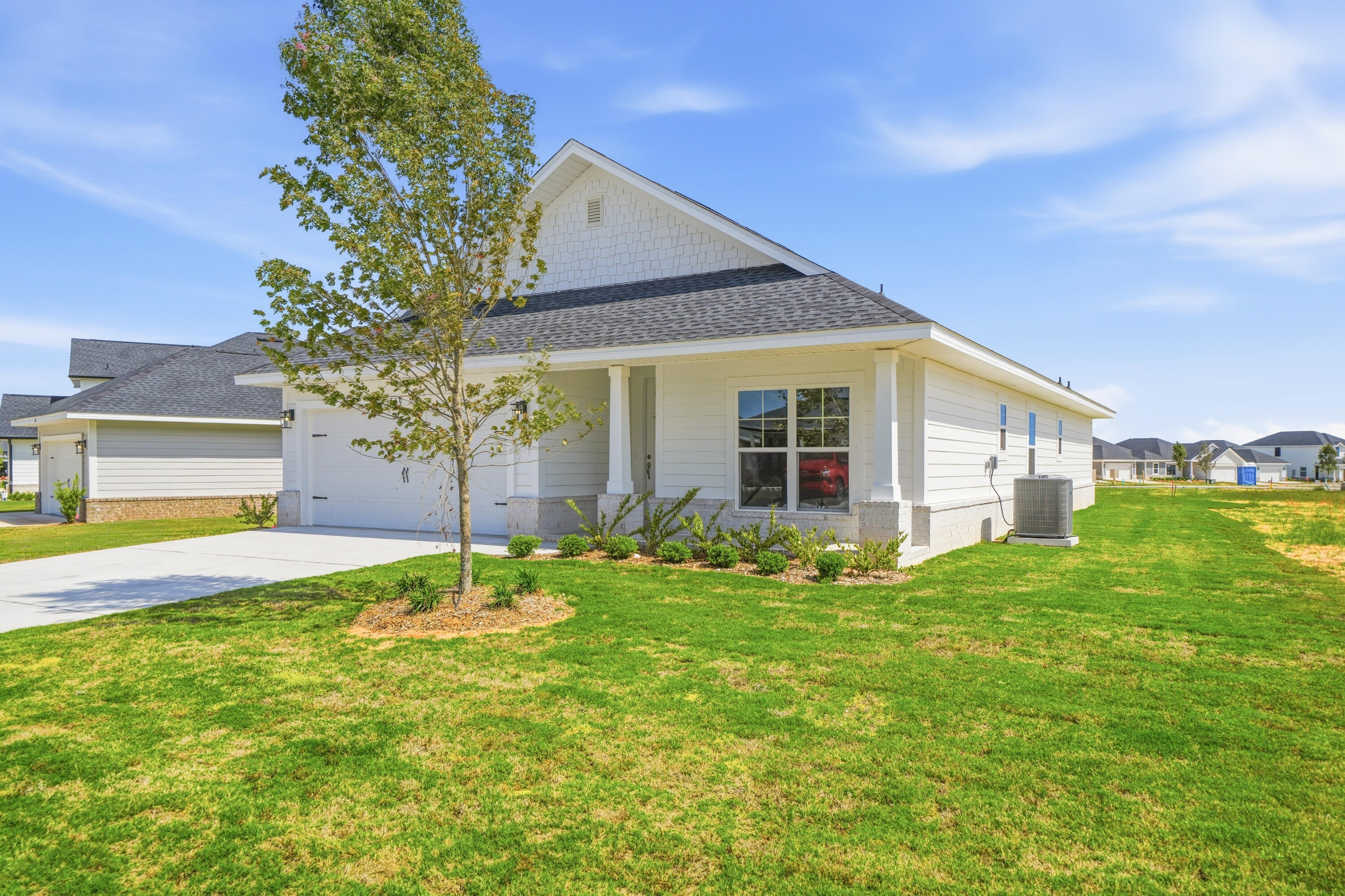 Brand-new construction featuring an open-concept floor plan with a spacious covered patio. The oversized primary bedroom suite offers a private retreat, while ceilings are a minimum of 9', with a cathedral ceiling in the main living area and a 10' tray ceiling in the primary bedroom. Eight-foot entry doors, upgraded LVP flooring throughout, and quartz countertops in the kitchen and baths complete this beautifully appointed home. Conveniently located just 20 minutes from the stunning 30A beaches.   *Some photos are of a similar home and other photos have been virtually staged to illustrate the property's potential.*