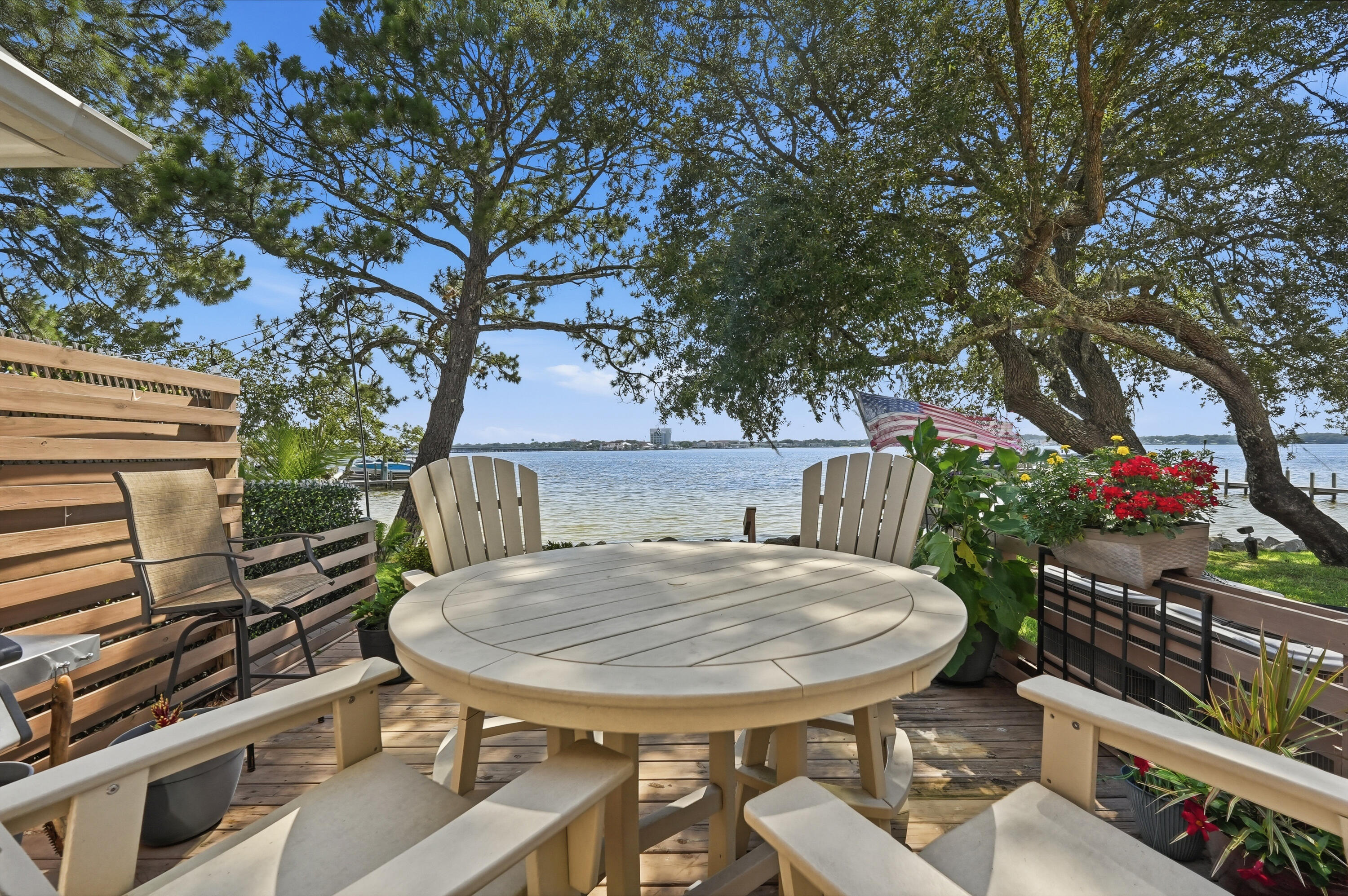 Experience waterfront living at its finest in this beautifully updated townhome on Garnier's Bayou, offering breathtaking sunset views, TWO boat slips, and hurricane impact-rated windows and sliding glass doors. Designed to maximize the stunning water views, this spacious home features an open-concept floor plan with expansive living and dining areas, plus a cozy wood-burning fireplace in the great room.

The updated kitchen is ideal for entertaining, featuring quartz countertops, stainless steel appliances, abundant cabinetry, and a breakfast bar overlooking the main living area.

A highly desirable downstairs a primary suite with a full bath provides flexibility for guests, multi-generational living, or a private home office. Upstairs, the second waterfront primary suite offers spectacular bayou views, two walk-in closets, and an ensuite bath complete with a separate shower and oversized jetted tub.

Step outside to the oversized 15x18 waterfront deck with a motorized sunshade, the perfect place to relax and enjoy stunning sunsets over the bayou.

Additional features include a one-car garage, an additional dedicated parking space, and extra storage above the garage. Low HOA fees include lawn maintenance for easy, low-maintenance living.
Major updates include Roof (2018), Triple-Pane Hurricane Impact Windows & Sliding Glass Doors (2019), HVAC Systems (2020 & 2017), and Water Heater (2023). This exceptional waterfront property combines comfort, convenience, and an unbeatable boating lifestyle.