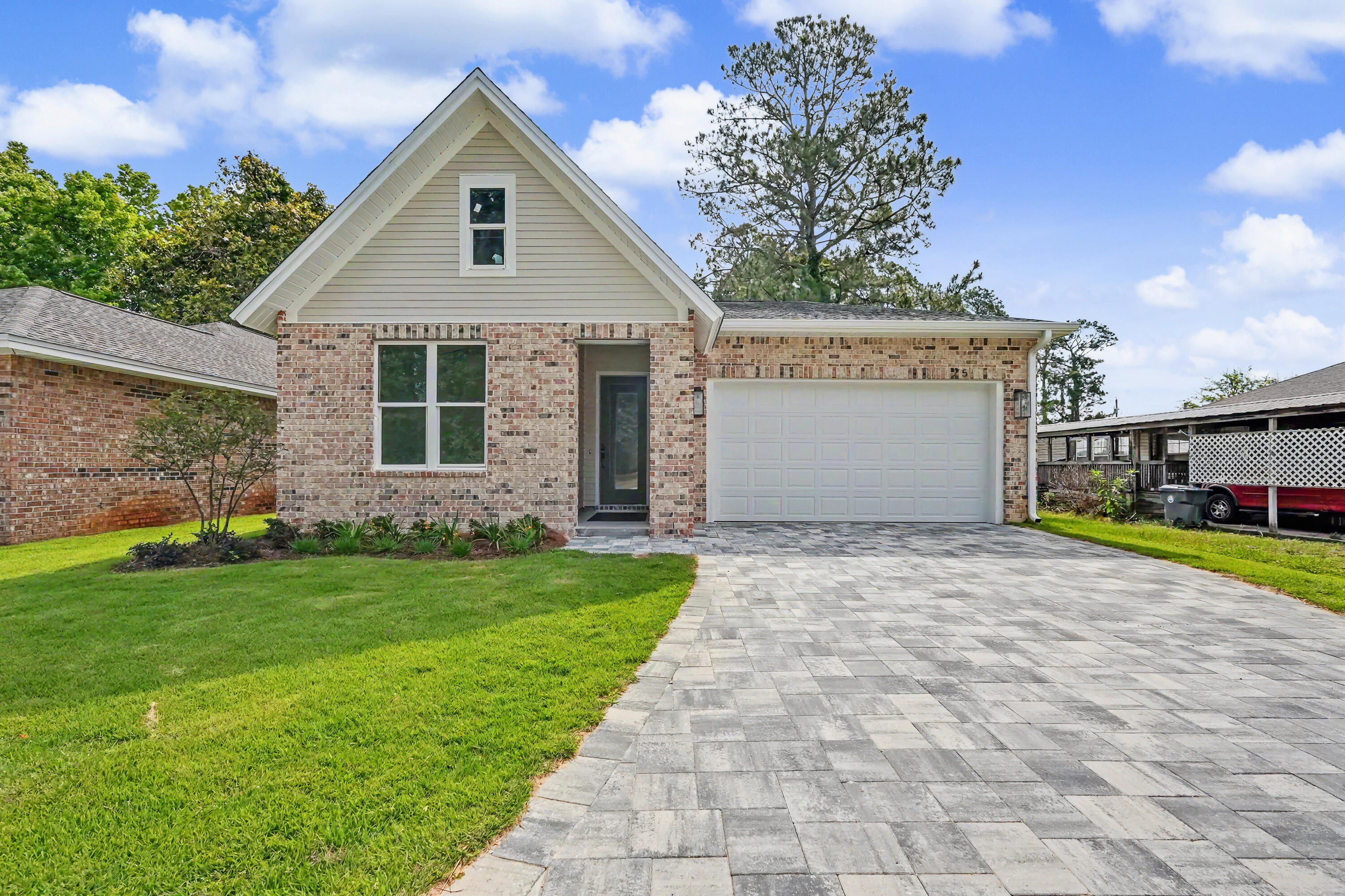 Gorgeous brand-new construction offering a thoughtfully designed split floor plan, high-end finishes, and exceptional functionality throughout. This home features a two-car garage with attic storage above and an upgraded paver extended driveway for added convenience and curb appeal.

Upon entry, you're welcomed by a wide hallway, soaring ten-foot ceilings, and beautiful French oak luxury vinyl plank flooring that flows seamlessly throughout the home. The spacious living area is filled with natural light and complemented by upgraded lighting fixtures, creating a warm and inviting atmosphere ideal for both relaxing and entertaining.

The kitchen is a true centerpiece, featuring stylish two-tone cabinetry, a large island, a walk-in pantry, and ample space for gathering and everyday living. The private primary suite is tucked away at the back of the home, offering peaceful views of the fully fenced backyard. The ensuite bath is beautifully appointed with custom designer tile, a large walk-in shower, dual vanities, and a separate water closet.

Secondary bedrooms are located off the front hallway, providing privacy for guests or family, with one bedroom featuring a walk-in closet. The guest bathroom includes a tiled surround bathtub and shower combination with upgraded finishes.

Just off the garage, you'll find a convenient landing zone complete with custom built-ins and hooks--perfect for keeping everyday essentials organized.

With its modern design, quality craftsmanship, and desirable layout, this move-in-ready home is the perfect blend of comfort and style.