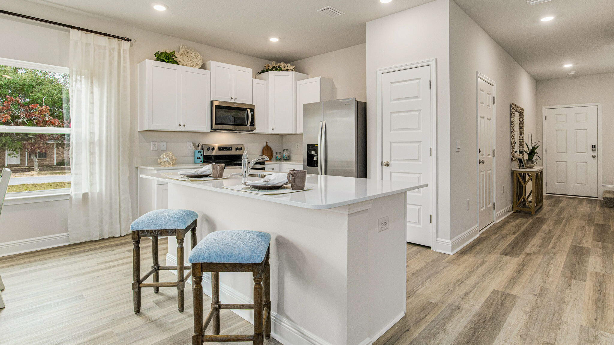Welcome to The Enclave at Midtown!

The Palm Interior Unit is a 2-story townhome that boasts 3 bedrooms, 2.5 baths with an open design that is perfect for entertaining. The kitchen is presented with quartz countertops, a large island bar, pantry and all stainless-steel appliances offering style and functionality. Bedroom 1 is located on the second floor as a private retreat with a spacious walk-in closet and a beautiful adjoining bath. Interior features also include EVP flooring with frieze carpet in the bedrooms. ALL LISTING pictures, colors, features, and size may vary. Square footages are approximate.
