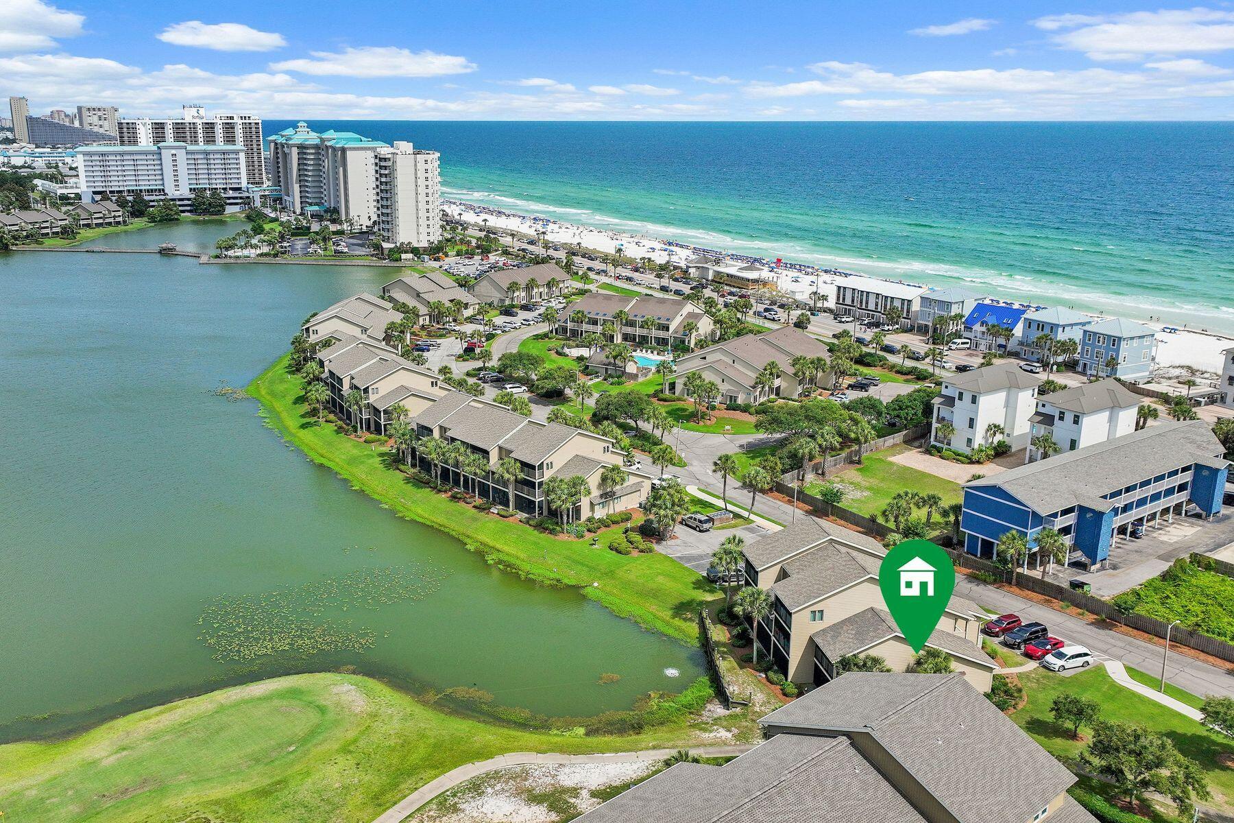 IMPRESSIVE RENTAL HISTORY & $57K+ in GROSS RENTAL INCOME ALREADY FOR 2026 & STILL BOOKING! Nestled within the sought-after Lakefront Villas enclave of Seascape Resort, this beautifully updated end-unit townhouse offers a front-row seat to some of the community's most picturesque views. Overlooking Stewart Lake and the 14th fairway, the residence combines the tranquility of a waterfront setting with the convenience of resort living just moments from the beach. Additional side windows unique to its corner location fill the home with natural light, while the absence of neighbors above or below creates the privacy and feel of a single-family residence.

Inside, thoughtful renovations elevate every space. The open-concept living area features high ceilings, recessed lighting, tile and luxury vinyl plank flooring, and seamless flow between the kitchen, dining and living spaces. The renovated kitchen is designed for both entertaining and everyday enjoyment, offering quartz countertops, stainless steel appliances, a wine refrigerator and abundant storage. Updated bathrooms showcase quartz-topped vanities and beautifully tiled walk-in showers, continuing the home's polished coastal aesthetic.

The flexible three-bedroom floor plan accommodates owners and guests with ease. A first-floor guest bedroom has direct access to a shared bath, while upstairs, the lakefront primary suite serves as a private retreat with a sitting area and a screened balcony overlooking the water. A second upstairs guest bedroom provides additional privacy, and dual screened balconies create inviting outdoor spaces for morning coffee, afternoon breezes and sunset views across the lake and fairway.

Equally impressive is the extensive list of improvements already completed. A new roof, impact-rated windows and doors, and Hardie board siding were installed in 2022, followed by a new HVAC system in 2023 and a new water heater in 2026, allowing the next owner to focus on enjoying the property rather than updating it.

Life at Seascape Resort extends far beyond the front door. With 300 acres of lush greens and tranquil lakes, easy and convenient access to more than 2,000 feet of deeded sugar-white beach frontage, and five community pools, including a heated pool nearby, you are sure to have year-round enjoyment. Residents and guests also enjoy tennis and pickleball courts, golf, basketball courts, playgrounds, picnic areas, on-site dining and entertainment, golf cart & bike rentals, as well as the nearby shops and restaurants at Seascape Towne Center and along pedestrian friendly Scenic Highway 98. Whether envisioned as a primary residence, vacation retreat, or investment opportunity, this turnkey property delivers an exceptional coastal lifestyle in the heart of Miramar Beach.