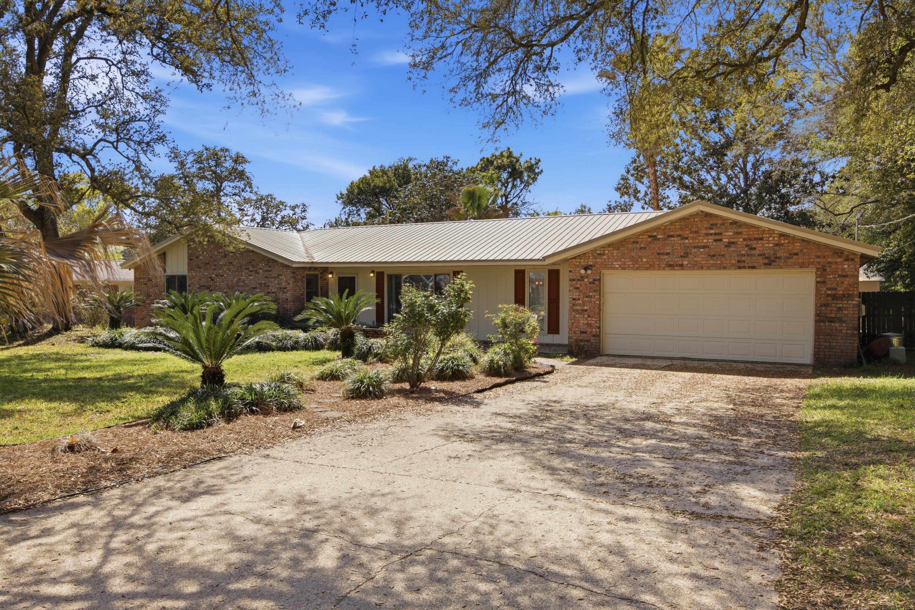 ***Home Sweet Home*** VA Assumable loan - 2.25%. Across from the Golf course!! This 4 bed, 2 bath 2 car garage home offers a comfortable, OPEN layout, inviting FIREPLACE, and dedicated DINING space-perfect for everyday living.The kitchen features GRANITE countertops, NEW appliances, and a PANTRY, while the primary suite includes a LARGE closet and an UPDATED vanity for a fresh, functional feel. Major upgrades include HVAC (2024), WATER HEATER (2025), and a METAL ROOF (2017), giving you peace of mind. Step outside to a PRIVATE OVERSIZED backyard surrounded by MATURE trees, complete with a GAZEBO and a Privacy fence with Rear access from 12th Street (great for Boat or RV storage) Large Shed and storage room off the garage, PAID OFF solar panels keep the power bill around $30/month. This home checks all the boxes for comfort,efficiency, and location