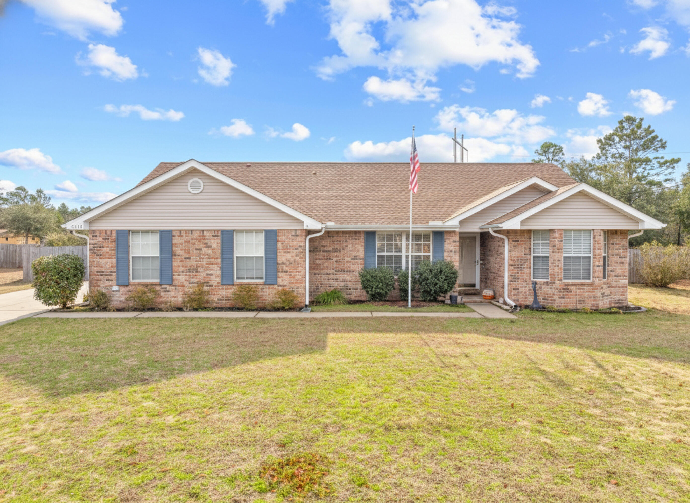 This well maintained 3 bedroom, 2 bathroom all brick home sits on a rare 1.04-acre, completely level lot and offers peace of mind with a newer roof (2021) and HVAC 2022. The open layout features tall cathedral ceilings in the living room that flow into the kitchen, highlighted by updated stainless steel appliances and a cozy wood-burning fireplace. The seller has replaced all carpet throughout, making for easy maintenance. Outside, enjoy a fully fenced backyard with a perfectly sized double gate to pull through your toys, along with plenty of space to spread out and store them. With no neighbors behind you, the backyard feels quiet and private, backing up to nature. Additional features include a newer 18x30 workshop valued at approximately $19,000 with electrical and wiring for both 110 a and 220V, an above-ground pool with a new pump for hot Florida summers, and a hot tub for cooler evenings. A screened porch off the living room provides extra space to relax. The meticulous seller recently had the septic tank pumped in December 2025 and maintains an annual pest and termite bond with Cook Pest Control. This one checks all the boxes and won't last long.