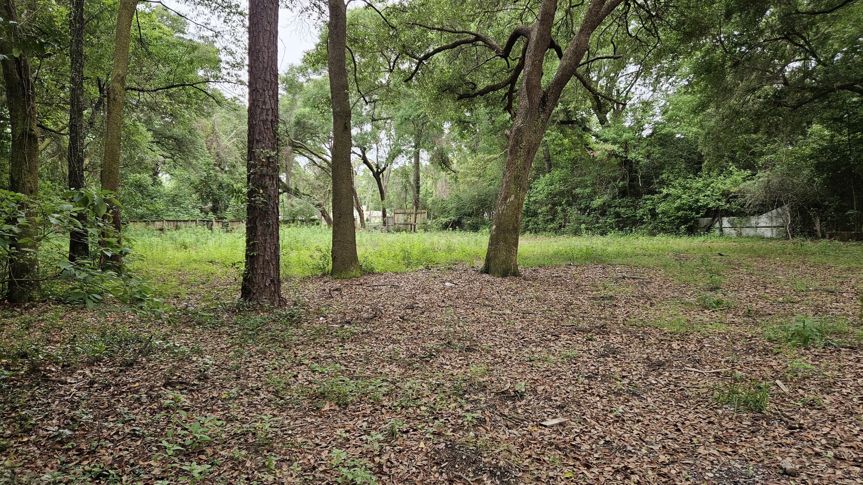 Build your dream home or place a new mobile home on this spacious, mostly cleared lot just under half an acre! Surrounded by mature oak trees and located in a quiet area, this property offers a great blend of privacy and convenience. Previously improved with a mobile home, the lot already has water and electrical taps available, and a septic system is believed to remain on site. Plenty of room for your vision with a head start on utilities and site preparation. A great opportunity for a homesite, investment property, or future development! Zoned HDMU.