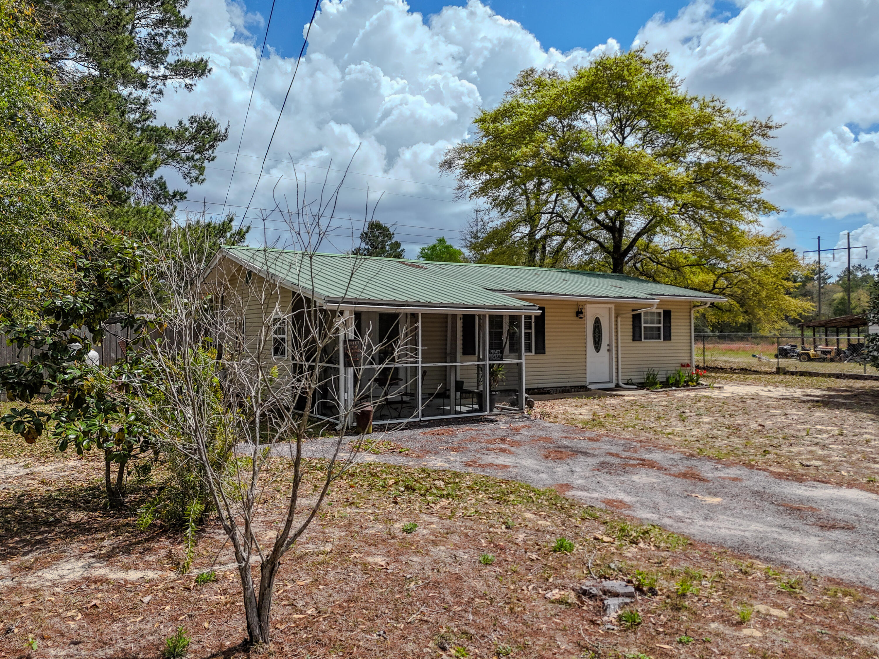 Great home located just minutes from DeFuniak Springs! This home is officially a 2BR/1BA, but has a large bonus room that could easily become a 3rd bedroom. The open-concept kitchen and living space create a welcoming flow, perfect for everyday living and entertaining. The home features durable and stylish LVP flooring throughout, adding a modern touch with easy maintenance. The updated bathroom and on-demand hot water heater provide added comfort and efficiency. Enjoy a charming sunroom on the back, perfect for entertaining, as well as a screened porch on the front of the home. An above-ground pool takes center stage in the fenced backyard for endless hours of summer fun. Two yard buildings are a bonus for added storage. Convenient commute to Crestview, Eglin AFB, and Interstate 10.