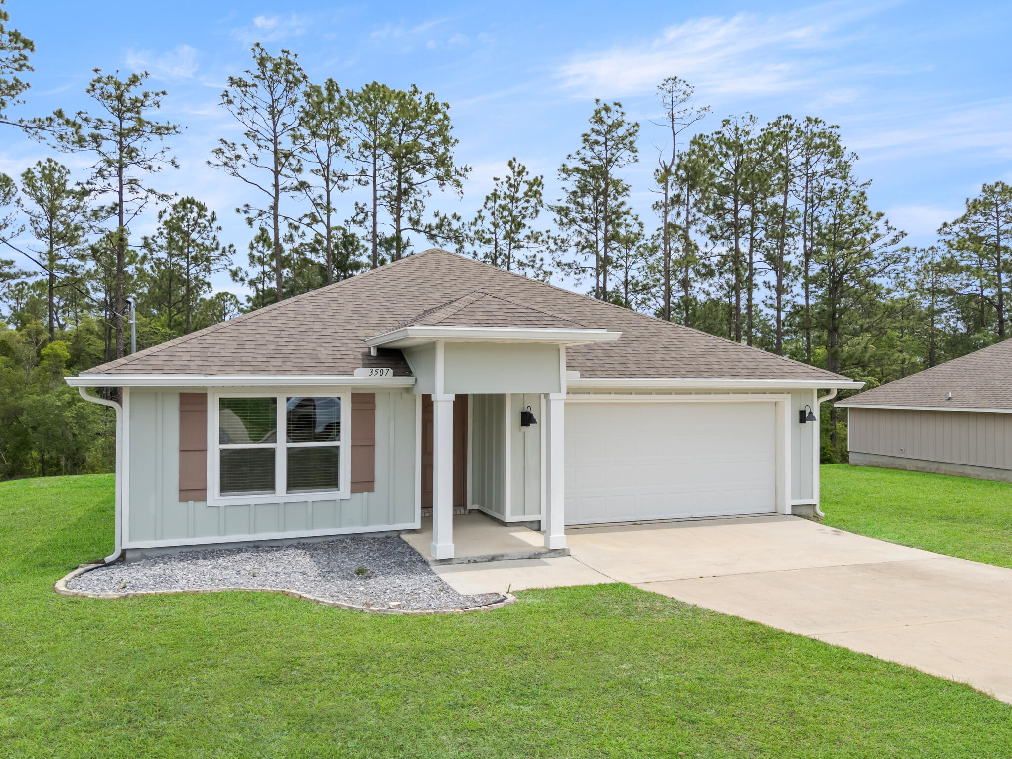 Tucked away in the quiet community of Timberland Ridge in North Crestview, 3507 Malus Court feels like the kind of home where life instantly slows down the moment you pull into the driveway. Built in 2022 and sitting on over a third of an acre, this property offers something that's becoming harder and harder to find -- space, privacy, and a backyard that stretches into the woods behind the home, creating a peaceful natural setting right outside your door.

As you step inside, the home immediately opens up with a bright and airy floor plan designed for both everyday living and entertaining. The engineered vinyl plank flooring flows throughout the main living areas, while the kitchen naturally becomes the heart of the home with its oversized island, stainless steel appliances, updated cabinet finishes, installed drawer pulls, and open sightlines into the living and dining spaces. Whether it's hosting family for the holidays, helping with homework at the counter, or enjoying a quiet morning coffee before the day begins, this home was designed for the moments that matter most.

Natural light pours through the windows, while blinds throughout the home and ceiling fans in every room add comfort and practicality already in place for the next owner.

The split bedroom design offers an ideal balance of privacy and functionality. Three guest bedrooms are positioned toward the front of the home, creating the perfect setup for family, guests, a home office, or hobby spaces. Tucked away near the back of the home, the primary suite becomes its own private retreat with a spacious ensuite featuring double vanities, a standalone shower, and not one, but two closets.

Step outside onto the covered back porch and you'll quickly understand what makes this property special. With the lot extending into the wooded backdrop behind the home, there's a sense of peace and separation that's hard to put into words. It's the perfect spot for slow mornings, weekend grilling, evening conversations, or simply enjoying the quiet surroundings after a long day.

Located in one of North Crestview's growing communities and priced at $303,000, this move-in ready Craftsman-style home blends modern convenience, thoughtful design, and the kind of setting that truly feels like home.
