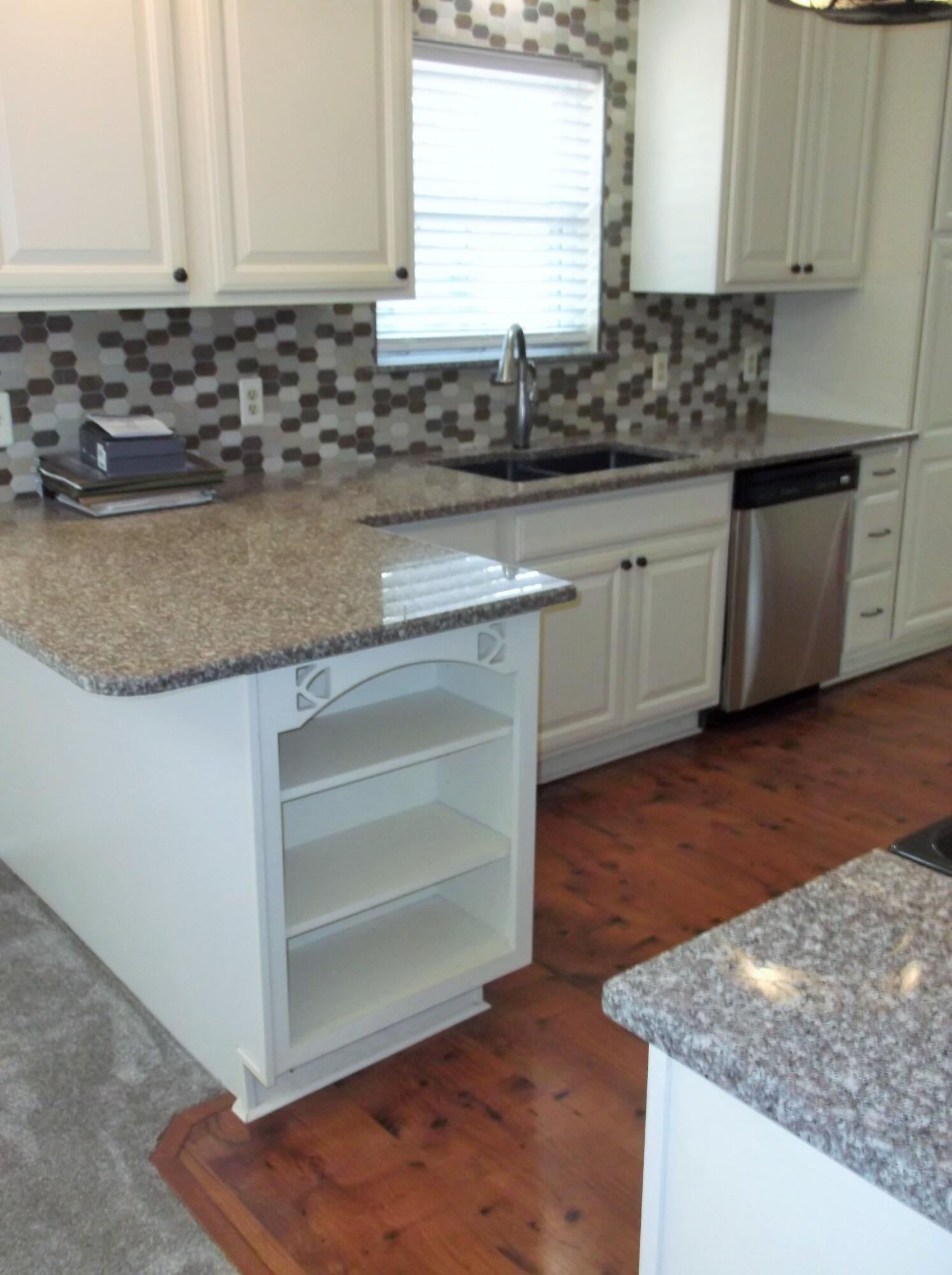 This well-maintained home offers a comfortable layout with both a living room & a separate den, giving you extra space for everyday living or entertaining. The kitchen has been updated with granite countertops, soft-close cabinets, tile backsplash, & a built-in microwave, making it a functional & inviting space.  New Refrig. June 2026. The interior has also been recently painted, and new carpet has been installed throughout. Several major updates have already been completed, including a new AC unit in 2022, water heater in 2025, & a whole-house generator. The metal roof was replaced in 2013, and the windows were updated in 2010 & come with a transferable lifetime warranty. The home also features copper wiring. Outside, there are 2-yard buildings that provide additional storage space and will convey as-is.