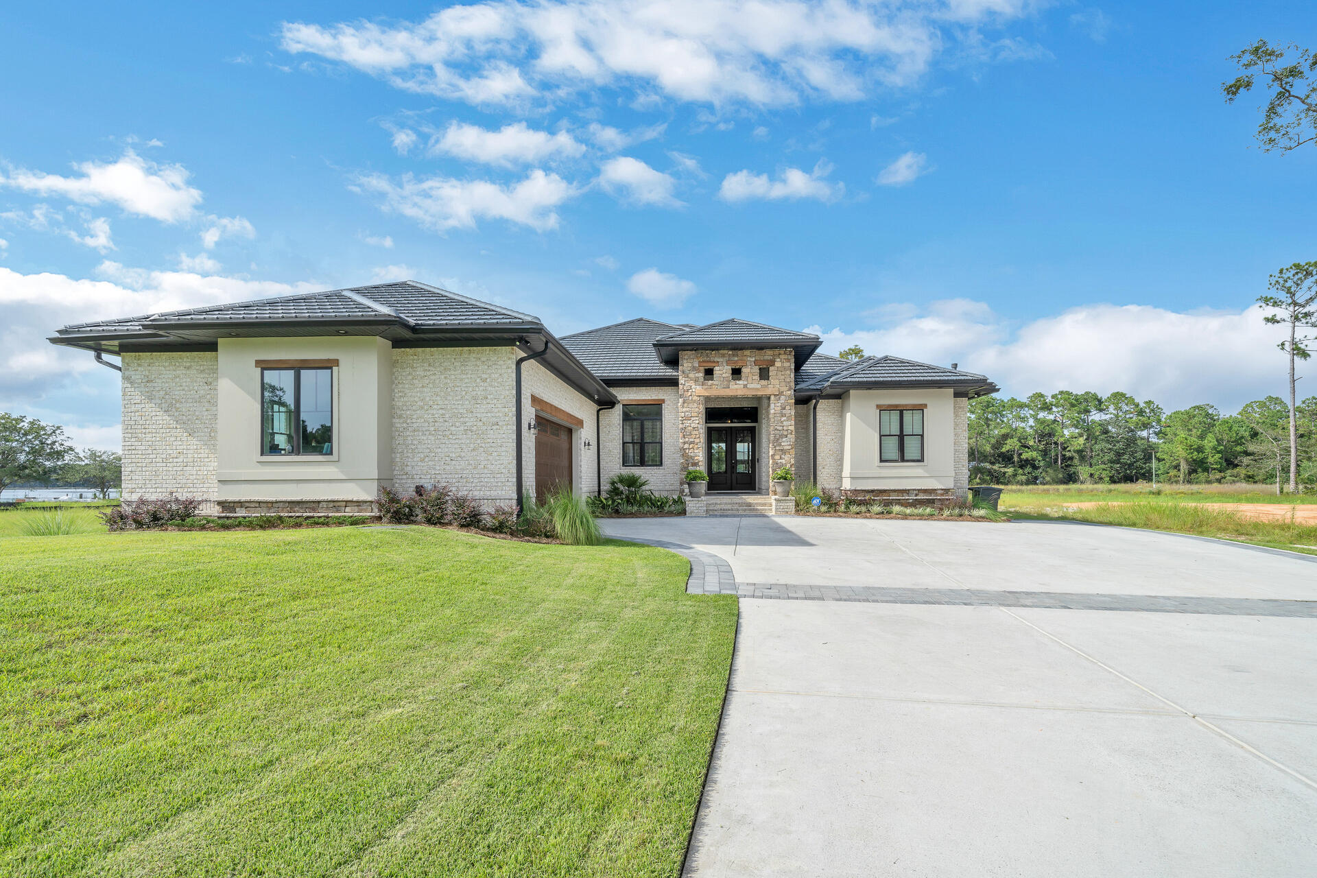 Boating & Fishing HEAVEN! Waterfront, custom-built home with 10,000lb boat lift, waverunner lift, pro cleaning station and covered fire pit nestled in the safe haven waters of Lagrange Bayou.  Easy access to the Bay and quick ride to the Gulf Pass.  3B/3B with dedicated office and a bonus room currently being used as a second office that can easily be converted to a 4th bedroom.  Enjoy spectacular waterviews from the comfort of your open living/kitchen/dining plus an incredible 20x37' screened lanai with adjacent covered, outdoor kitchen. Contemporary brick and hand-laid stone with cypress accents, slate metal roof, wood-look tile floors, three-stage crown molding...every attention to detail is found in this custom Builder's home. Schedule a private showing today.  Bayou tour available by request.