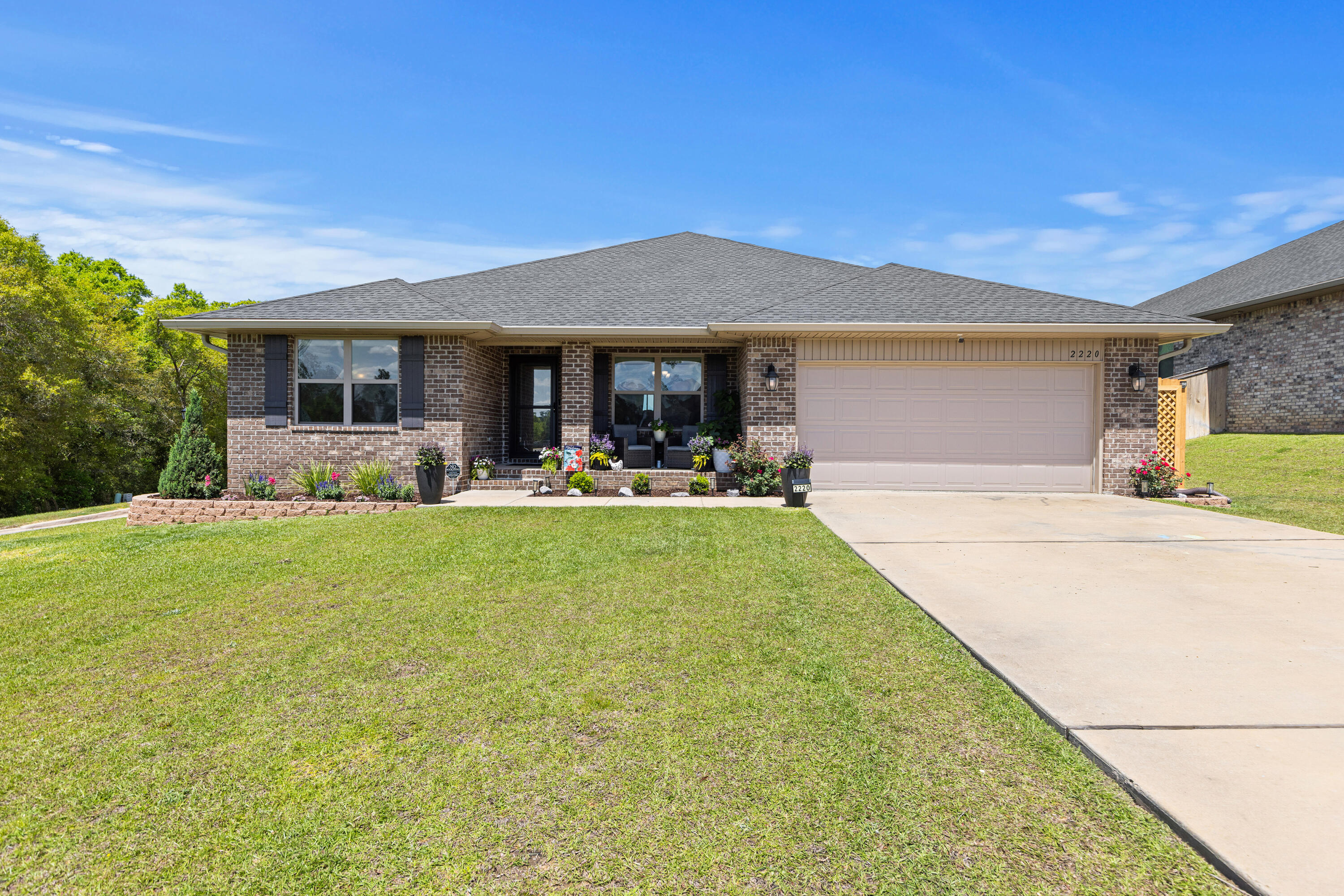 **Sellers offering closing cost assistance** This all brick, 4-bed, 2-bath, 2-car garage home sits on a quarter acre corner lot in Charleston Place. This home is only 4 years old and comes with a few upgrades already provided by the owners, such as a fully screened back porch, newly built deck and cozy firepit area complimented by beautiful landscaping. On the interior, this split floor plan offers tons of space with the primary bedroom/bathroom on one side of the home and the additional 3 bedrooms on the other.  The primary bedroom is oversized and ready to accommodate all your furniture very easily. The primary bathroom has a separate tub and shower, double sinks, and large walk-in closet. The kitchen and living room feel a little more grand with a vaulted ceiling and open concept. The kitchen is equipped with granite countertops, stainless appliances, and pantry.  With irrigation, seamless gutters and two covered porches, this home is always ready for the Florida heat. VA Loan Assumption available to VA eligible buyers (Rate 4.875% and minimal gap).