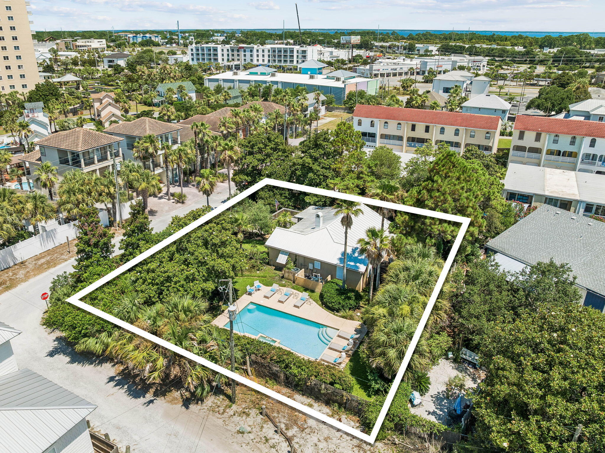 Rare opportunities like this are becoming increasingly difficult to find. This approximately 0.3 acre homesite sits just steps from the beach access across the  street and offers exceptional redevelopment potential, subject to buyer verification. Situated in the heart of Miramar Beach, this unique property combines an estate-sized homesite with an unbeatable location. Whether you're searching for a primary residence, second home, investment property, or exploring redevelopment opportunities, the possibilities are as compelling as the location itself. The beautifully landscaped grounds feature mature palms, shade trees, lush lawn, a private pool, and a fully fenced yard, creating a private setting rarely found this close to the beach. The home's elevated position enhances both privacy and outdoor enjoyment. The existing residence has been thoughtfully updated with granite countertops, upgraded cabinetry, and quality interior finishes. Built with durable concrete block construction, a stucco exterior, a metal roof, and hurricane shutters, the home also offers a spacious front porch with both screened and open-air living areas, plus a private rear porch overlooking the tranquil garden. Leave the car behind and enjoy one of the property's greatest advantages. Beach access is directly across the street, placing the sugar white sand and emerald green waters just moments away. Nearby destinations include Silver Sands Premium Outlets, Sandestin Golf and Beach Resort, Grand Boulevard, championship golf courses, restaurants, shopping, and entertainment.