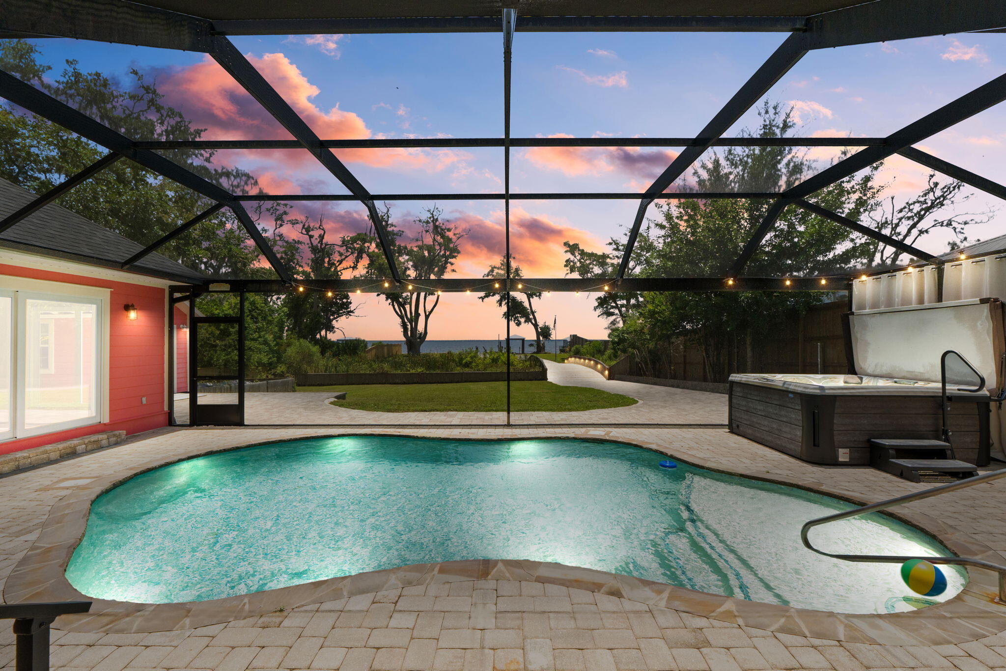 Waterfront multigenerational dream home on half an acre, all on one level and fully fenced for privacy, security, and fun. This rare property offers two separate homes, a covered pool, private dock, and tons of parking--perfect for a large family, multi-gen living, or a primary residence with incredible Airbnb/short-term rental potential.

The main home is a spacious 3 bedroom, 2 bathroom layout with easy, single-level living and water views. The second home is also a 3 bedroom, 2 bathroom layout and includes a true mother-in-law suite with its own full kitchen, bathroom, and private access that leads directly out to the covered pool area--ideal for extended family, guests, or income-producing space. Multiple living areas, split bedrooms, and separate entrances give everyone room to spread out while still feeling connected.

Step outside to your own private resort: a screened/covered pool just steps from both homes, a private dock for boating, fishing, or paddleboarding, and a fully fenced yard with privacy fence and gated entry. The oversized lot (approximately half an acre) offers room for kids, pets, toys, and gatherings, with ample driveway space and parking for cars, RV, or boat. This is an entertainer's paradise and a true lifestyle property--waterfront living, no stairs, multiple kitchens, and flexible spaces that can adapt as your needs change.