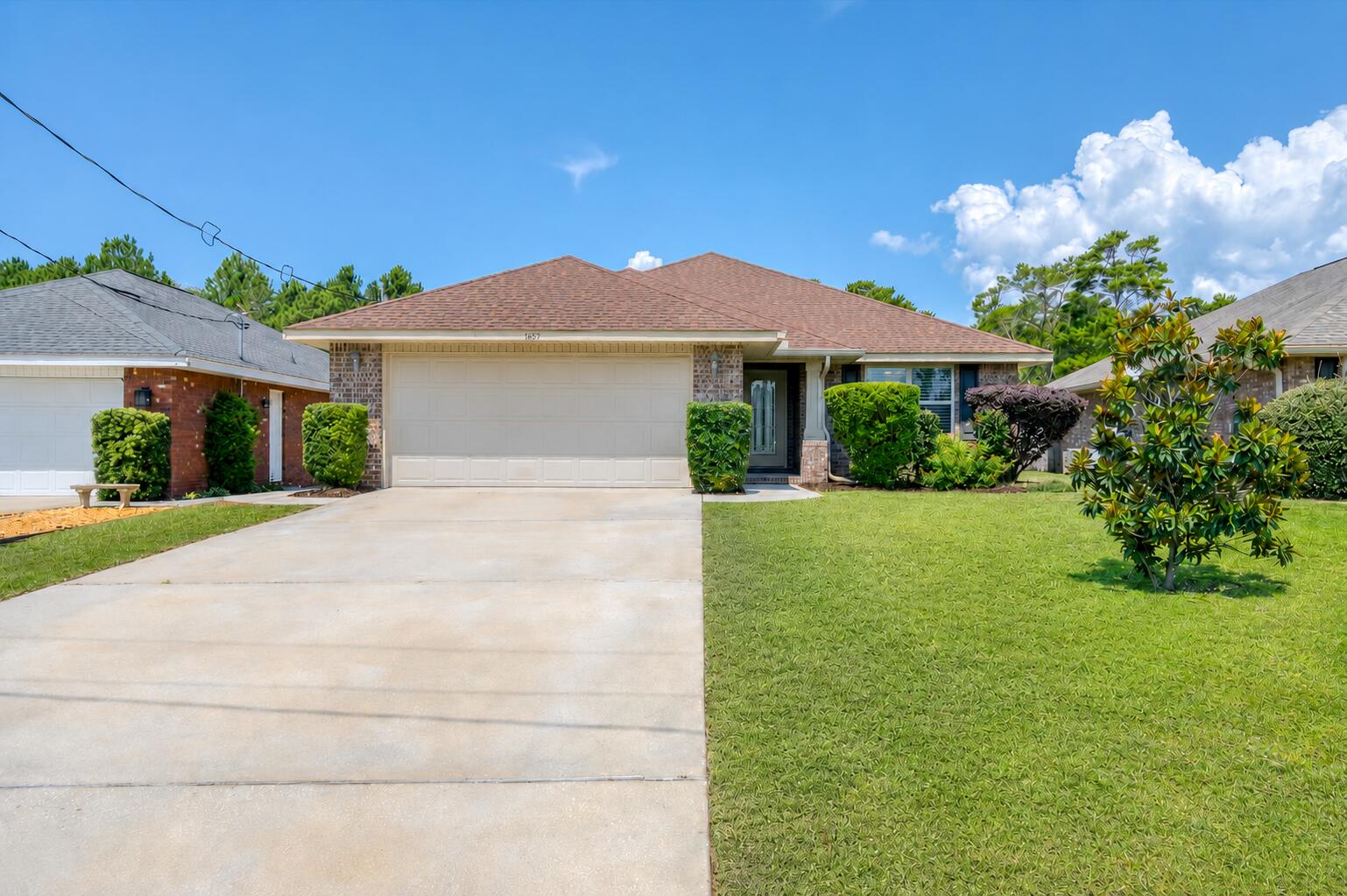 Built in 2018 and situated on a generous one-third acre lot, this move-in ready home offers a spacious backyard and a thoughtfully designed interior. The fully fenced backyard has a private, secret garden feel, blending open green space with a wooded backdrop. Two winding walking paths invite you to explore, while a 7x7 storage shed, generous yard space, irrigation well, sprinkler system, and natural surroundings provide endless possibilities for a fire pit, gardening, pets, or outdoor gatherings. This home sits in a neighborhood with no HOA and a great location being positioned just off Highway 98, 15 min to Navarre Beach and next door to the Gulf Breeze Zoo and the brand-new Soundside High School. Inside, the home features an open floor plan with vaulted ceilings, wood-look flooring throughout the main living areas, and a neutral color palette that complements any style. The kitchen features aesthetic beadboard cabinetry, striking granite countertops, stainless steel appliances, and an adjacent laundry room with additional pantry storage. A breakfast nook provides an area for casual dining, while the formal dining room offers additional space for entertaining. Just off the living room, the covered patio extends your living space outdoors and includes a retractable sunshade for added privacy and comfort. The split-bedroom layout provides privacy for the spacious primary suite, featuring a tray ceiling, direct access to the covered patio, and an ensuite bathroom with all you could want: granite-topped double vanities, a garden tub, separate shower, private water closet, and a large walk-in closet! Two additional bedrooms are located on the opposite side of the home, each offering cozy carpet, ceiling fans, spacious closets, and access to a shared full bathroom. The home also has fabric hurricane shutters. Offering a flexible layout, spacious lot, and convenient location, this home is well suited for both comfortable everyday living and entertaining!