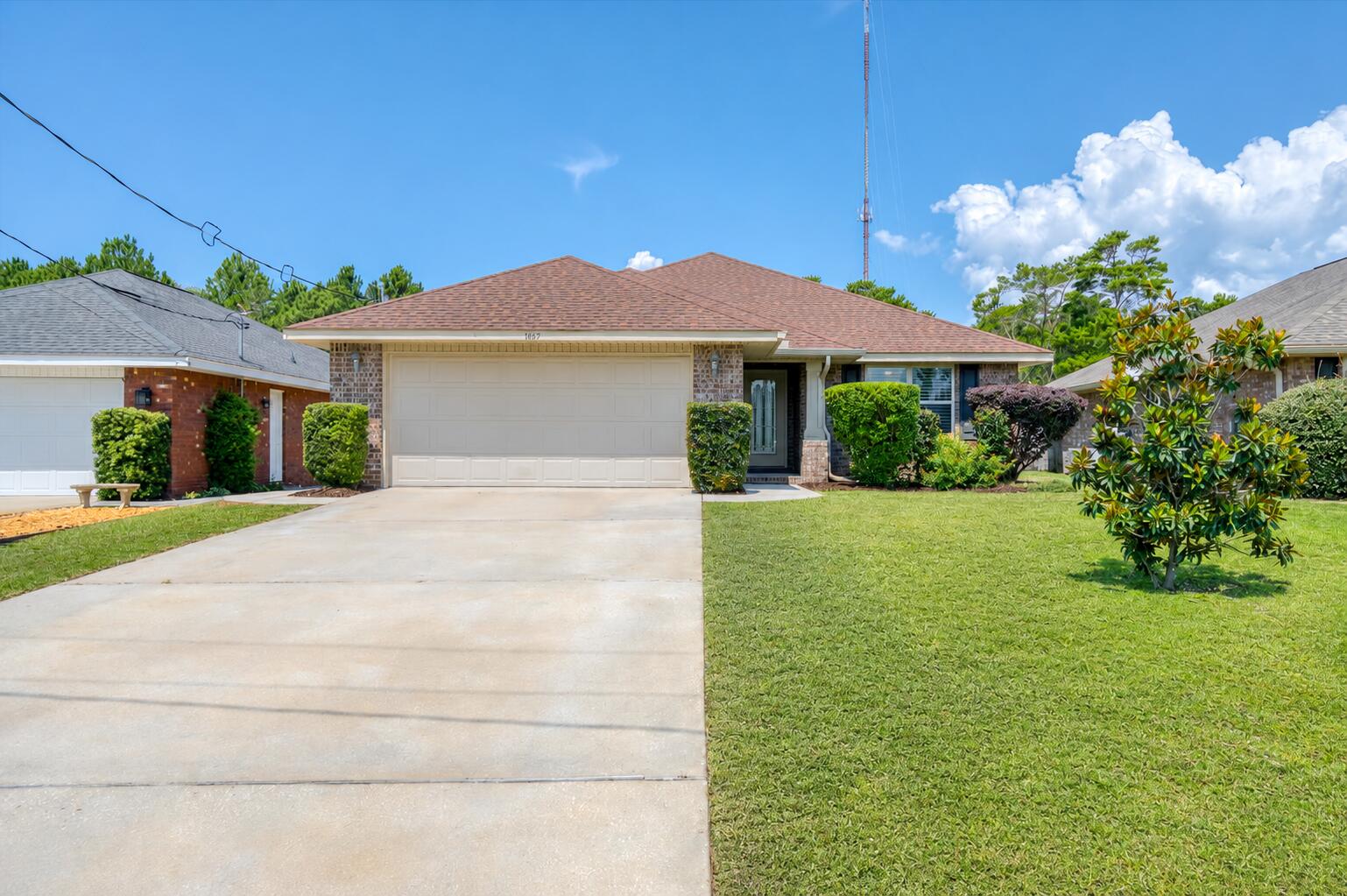 Built in 2018 and situated on a generous one-third acre lot, this move-in ready home offers a spacious backyard and a thoughtfully designed interior. The fully fenced backyard has a private, secret garden feel, blending open green space with a wooded backdrop. Two winding walking paths invite you to explore, while a 7x7 storage shed, generous yard space, irrigation well, sprinkler system, and natural surroundings provide endless possibilities for a fire pit, gardening, pets, or outdoor gatherings. This home sits in a neighborhood with no HOA and a great location being positioned just off Highway 98, 15 min to Navarre Beach and next door to the Gulf Breeze Zoo and the brand-new Soundside High School. Inside, the home features an open floor plan with vaulted ceilings, wood-look flooring throughout the main living areas, and a neutral color palette that complements any style. The kitchen features aesthetic beadboard cabinetry, striking granite countertops, stainless steel appliances, and an adjacent laundry room with additional pantry storage. A breakfast nook provides an area for casual dining, while the formal dining room offers additional space for entertaining. Just off the living room, the covered patio extends your living space outdoors and includes a retractable sunshade for added privacy and comfort. The split-bedroom layout provides privacy for the spacious primary suite, featuring a tray ceiling, direct access to the covered patio, and an ensuite bathroom with all you could want: granite-topped double vanities, a garden tub, separate shower, private water closet, and a large walk-in closet! Two additional bedrooms are located on the opposite side of the home, each offering cozy carpet, ceiling fans, spacious closets, and access to a shared full bathroom. The home also has fabric hurricane shutters. Offering a flexible layout, spacious lot, and convenient location, this home is well suited for both comfortable everyday living and entertaining!