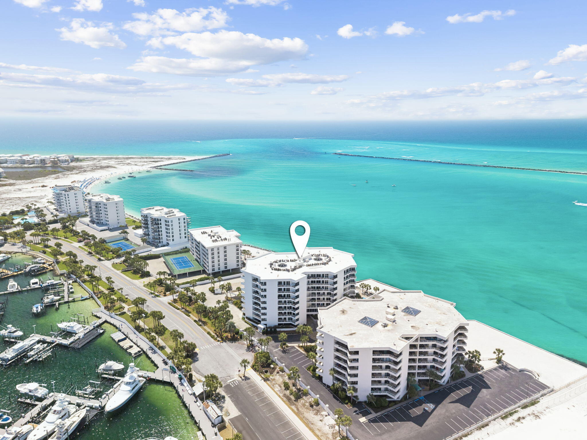 Boat Slip available for separate purchase - A Rare Opportunity to Own the Complete Destin Waterfront Lifestyle.
Experience refined coastal living at East Pass Towers, where luxury meets effortless boating convenience. This beautifully renovated 4th-floor residence offers captivating views of Destin Harbor and the East Pass, setting the stage for days that begin and end on the water.

Inside, walls of floor-to-ceiling glass flood the space with natural light and frame the coastal backdrop, while a spacious private balcony invites morning coffee and sunset unwinding with harbor activity below. The open-concept design flows seamlessly through the living, dining, and kitchen areas--featuring modern cabinetry, a large island, and custom pantry-ideal for relaxation and entertaining. Two generous bedrooms and updated baths offer comfort and privacy, while thoughtful renovations throughout create a polished, move-in-ready residence.

What truly sets this offering apart is the ability to purchase a boat slip in conjunction with the condo--an increasingly rare advantage in Destin--placing effortless access to the Gulf right at your doorstep. Launch for a day of fishing, cruising, or waterfront dining within minutes.

East Pass Towers has recently completed significant upgrades, with SIRS complete and all assessments paid, delivering both confidence and long-term value. This gated, rental-restricted community (3-month minimum) ensures a quieter, more private residential experience.

Amenities include a private beach area, seasonally heated pool and spa, fitness center with sauna, owner's club room, covered parking, and dedicated storage. Just across the street, the marina and water taxi provide seamless access to the harbor's premier dining and entertainment.  Only 5 minutes to Gulf of Mexico with no bridge clearance.  East Pass Towers Marina is designated as a "Clean Marina" by the Florida Department of Environmental Protection. Facilities include pump out connections at slip side, 50-amp electrical service in a secure, gated environment. Adjacent to Norriego Point Park...Destin's newest public beachfront park.

This is more than a condo--it's a turnkey waterfront lifestyle, where luxury living and boating come together in one of Destin's most exclusive settings.