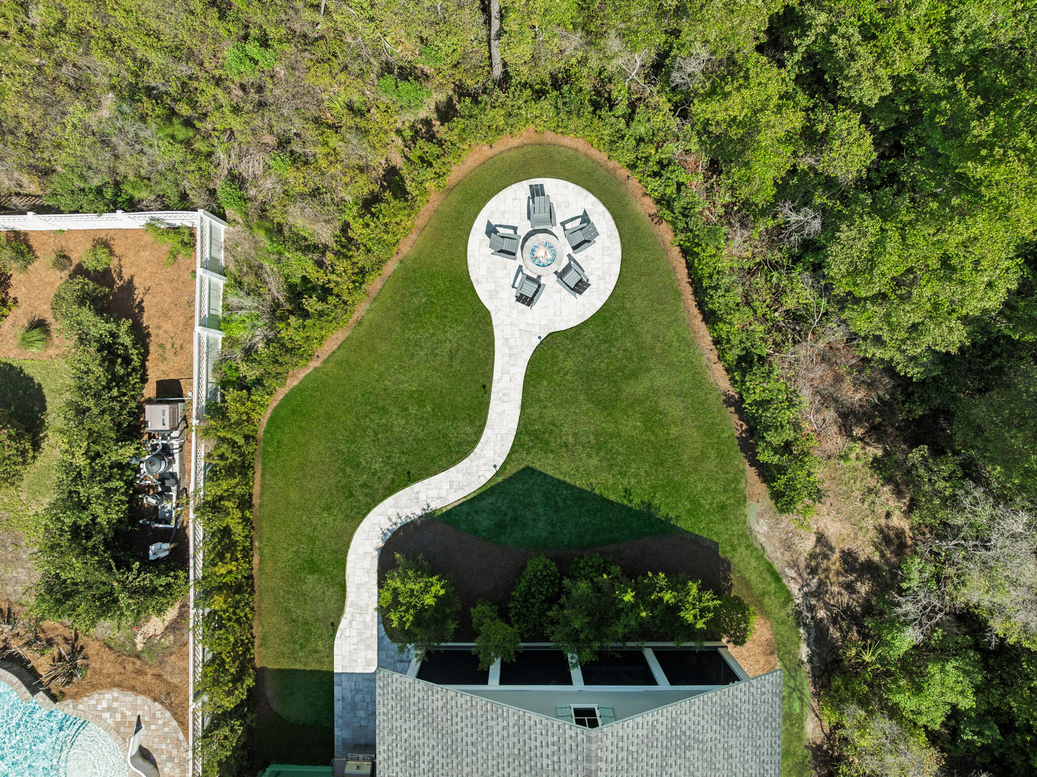 Located in WaterSound Origins, this Ficus plan built by Huff Homes, offers single-level living with over 2,500 square feet, four bedrooms, and a two-car garage, along with a series of thoughtful upgrades throughout.

The backyard is a standout feature, offering an oversized footprint with added privacy and mature, layered landscaping. Room for a pool and spa. Outdoor elements include a gas firepit, coquina shell gas fireplace, and a second set of porch doors that expand access from the main living area, creating multiple points of entry and a more connected layout.

Inside, the home features floor-to-ceiling shiplap in the living room, with additional shiplap detailing in the entry and primary bedroom. Ten-foot ceilings, crown molding, and Kingsley Medallion hardwood flooring run throughout, along with a 42-inch vented gas fireplace in the main living area.

The kitchen is equipped with stacked glass cabinetry with accent lighting, undercabinet lighting, a 36-inch Wolf range, and a 36-inch Sub-Zero built-in refrigerator.

Additional features include a gas lantern at the front porch, a stub for a gas grill with poured pad, security camera outlets, and an outdoor shower located adjacent to the garage, along with added exterior access at the garage for convenience.

A well-maintained home with a functional layout, elevated finishes, and a rare backyard setting within WaterSound Origins.