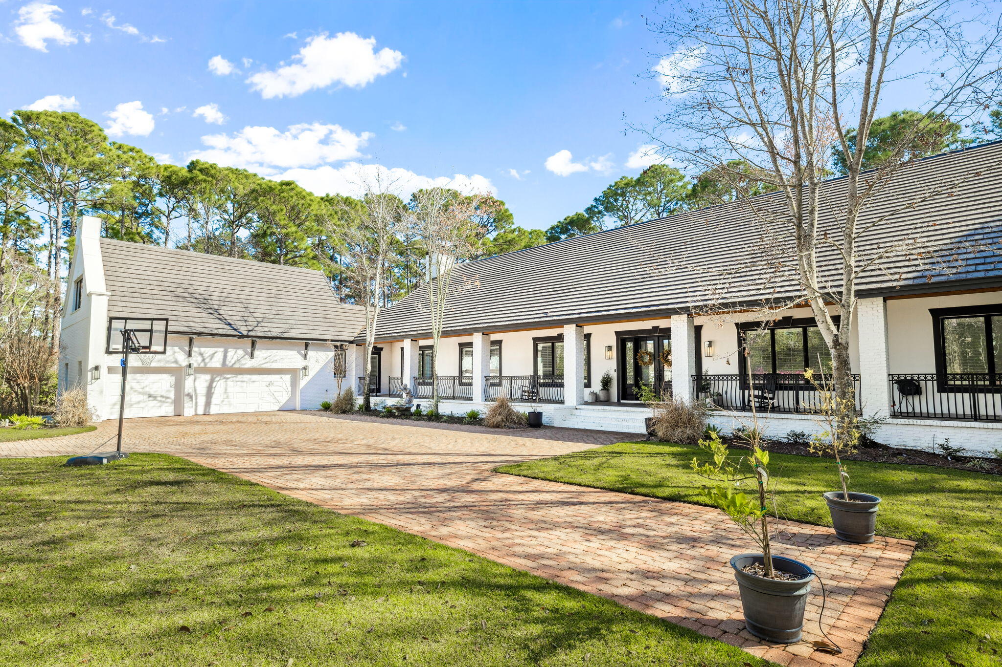 Located in the exclusive, gated community of Regatta Bay, this breathtaking home nestled at the end of a cul de sac backing to a conservation easement offers a private, peaceful place to call ''home.'' Sitting on over an acre of land, this luxurious home offers plenty of space to entertain and host family. Leading up to the home is a large driveway with ample parking and a three car garage framed ideally by a manicured landscape. Making your way up to the door, you'll find an expansive covered porch overlooking the private yard. You are welcomed into the home by a bright, open entry with a hallway spanning the front of the house for easy access to every space. The living room features a gorgeous gas fireplace framed by glistening white tiles that stretch to the vaulted ceilings.