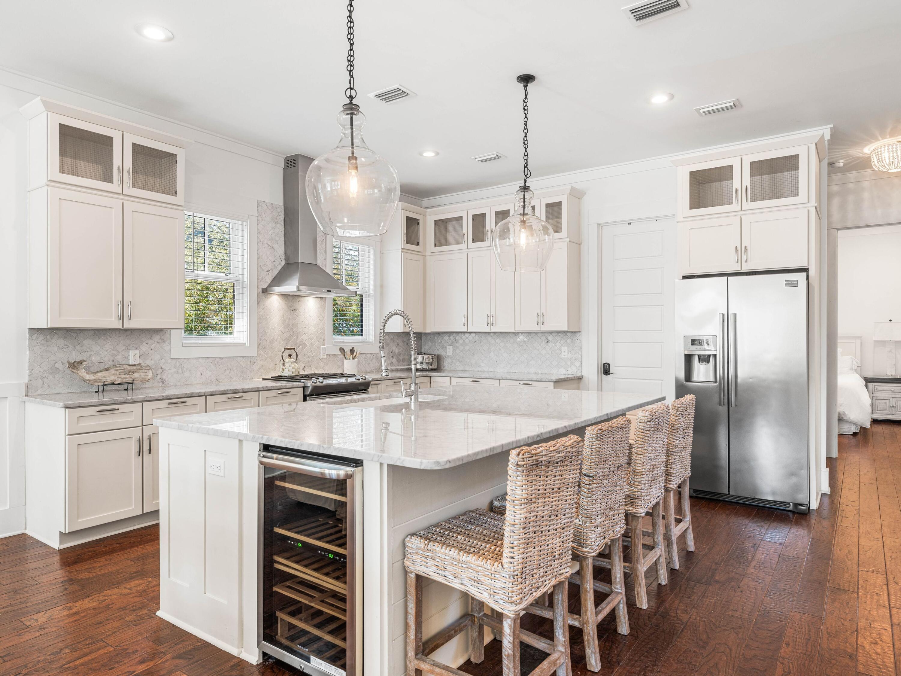 Located along a tranquil street within the exclusive WaterSound Beach community, this furnished residence offers a serene retreat with four bedrooms, four full baths and one powder bath.  An expansive 1,700 square feet of outdoor porches includes a spacious screened porch that features a private 14-foot spa. The sunlit open concept living and dining areas provide ample space for family gatherings, complemented by hardwood floors and intricate board and batten wall details.

The kitchen is a culinary haven, featuring a spacious center island adorned with marble countertops, custom cabinetry, and  stainless appliances, including a wine refrigerator. A comfortable guest suite with ensuite and powder bath are conveniently located on the first level. Ascend to the upper level to discover a spacious secondary living area complete with four built-in bunks. The master suite exudes opulence, characterized by a vaulted tongue and groove ceiling, a wraparound balcony, and an ensuite bath.

The second floor further enhances the property with an additional guest suite with ensuite and laundry. A spacious carriage house provides a welcoming space for guests, situated above the garage that accommodates one car and a golf cart. Recent enhancements include updated decorative lighting, furnishings, exterior painting, and enhanced landscaping.

The gated WaterSound Beach community, strategically located south of Scenic Highway 30A, offers homeowners a rare sense of seclusion while providing convenient access to a variety of recreational activities. Amenities include swimming pools, multiple parks, green spaces, a state-of-the-art fitness center, and private boardwalks leading to one of the most picturesque mile stretches of coastline in the region.