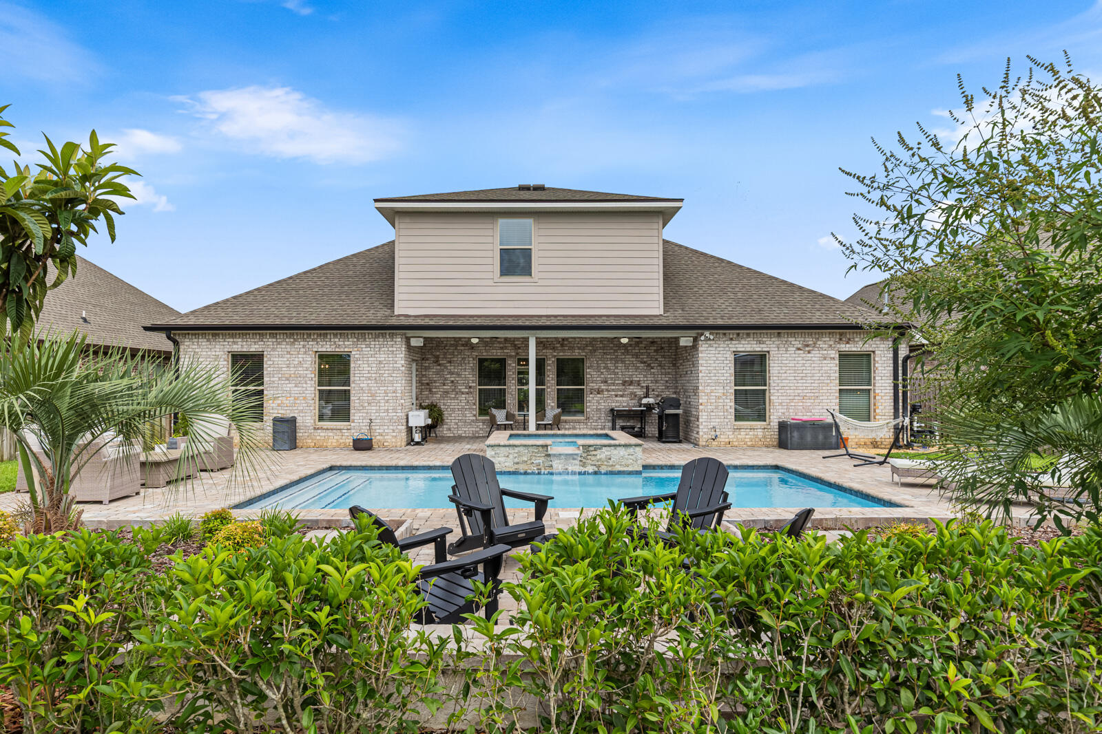 Welcome to this stunning pool home in The Trails at Hammock Bay! This beautifully designed two-story home offers 5 bedrooms, 3 full bathrooms, a dedicated office, a spacious game room, and an open-concept floor plan ideal for both entertaining and everyday living.
Interior upgrades include luxury wood-look tile flooring, quartz countertops, soft-close cabinetry, under-cabinet lighting, custom wood shelving, updated light fixtures, custom blinds, crown molding throughout the main living areas and primary suite, and a tray ceiling in the primary bedroom. The inviting living room features a cozy fireplace and large windows overlooking the beautifully landscaped backyard and sparkling pool. An oversized garage provides ample storage and functionality.
The private primary suite offers a double vanity, garden tub, separate shower, private water closet, and a spacious walk-in closet. Step outside to your own backyard retreat featuring a heated gunite pool and spa, paver patio, fire pit, covered porch, outdoor speakers, gas line, gutters, and a fully fenced backyard. Additional features include a Ring camera system, recessed lighting, ceiling fans throughout, and professional landscaping. This exceptional home combines comfort, style, and resort-style outdoor living. Located in the Hammock Bay master-planned community, residents enjoy access to an impressive array of amenities, including multiple resort-style pools, clubhouses, a fitness center, tennis, basketball, and pickleball courts, walking and biking trails, dog parks, playgrounds, and year-round community events. Additional community highlights include seasonal markets and the picturesque Lake Club overlooking the bay. Conveniently located near the white sand beaches of Scenic Highway 30A and South Walton, shopping, dining, and schools.