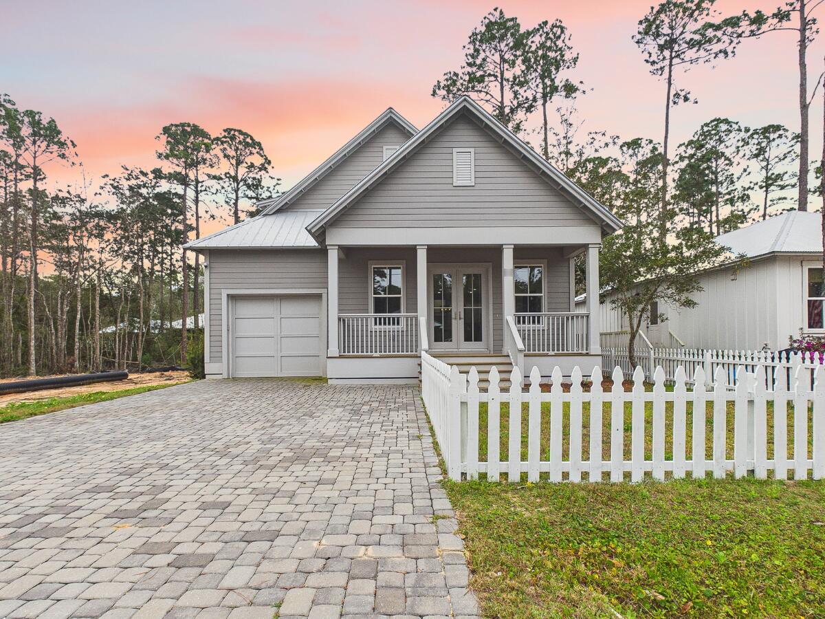 Discover coastal charm and modern luxury in this stunning Point Washington cottage, located in a premier community of full-time residents just minutes from the beaches of South Walton, where flood insurance is not required! A brick paver driveway and inviting front porch welcome you into a light-filled interior featuring durable luxury vinyl plank flooring and an open floor plan. The chef-inspired kitchen is a true highlight, boasting quartz countertops, shaker-style cabinetry, and upgraded stainless steel appliances including a gas range with a professional pot filler. The main-level primary suite offers a private retreat with a spa-like bath, while a whole-home water filtration system and a built-in workstation add everyday convenience. Designed for the quintessential Florida lifestyle, the exterior living spaces are perfect for entertaining. Host summer cookouts on the expansive screened back porch, which features a fully equipped outdoor kitchen and grill area. The property is beautifully enclosed by a new white picket fence and includes a dedicated dog run for pet owners. Ideally located a short walk from Bay access, this home is perfect for those looking to live, work, and play near 30A. Whether you are seeking a primary residence or an investment, this property delivers, with rental projections available upon request.