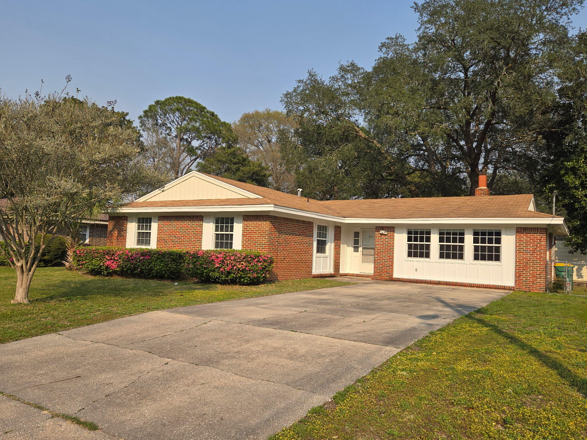 Nestled in the heart of Niceville, FL, this stunning 3-bedroom, 2-bath home offers 1,946 sq. ft. of beautifully updated living space. The kitchen, renovated in 2016, features sleek granite countertops, new appliances, a modern faucet, and updated fixtures and hardware. It boasts a side-by-side refrigerator, built-in microwave, oven/stove, and dishwasher. The kitchen includes a cozy eat-in area and adjoins a formal dining room with new sliding glass doors leading to a spacious screened patio.  This home offers versatile living areas. The living room opens to the dining room, perfect for entertaining, while another living room is anchored by a wood burning fireplace, creating a warm and inviting atmosphere. Enjoy outdoor living on the large recently re-screened patio (15'8''x9'11''), which overlooks a serene, fenced backyard that is accessible with a double gate on one side. Bring your boat or RV! The property also features new vinyl miami dade impact windows (2009), a roof replaced in 2009, and an HVAC system installed in 2019. Additional highlights include copper wiring(2023), easy-care solid surface flooring(2023), freshly painted interior with popcorn removed from ceilings (2023) and a sizeable storage building. This all-brick home is centrally located, offering easy access to Eglin AFB, EOD School, Northwest FL State College, shopping, dining, and top-rated schools. Seller to provide a roof replacement with an acceptable offer.  Ready for immediate move-in, this home combines convenience, comfort, and modern updates in a highly desirable location.