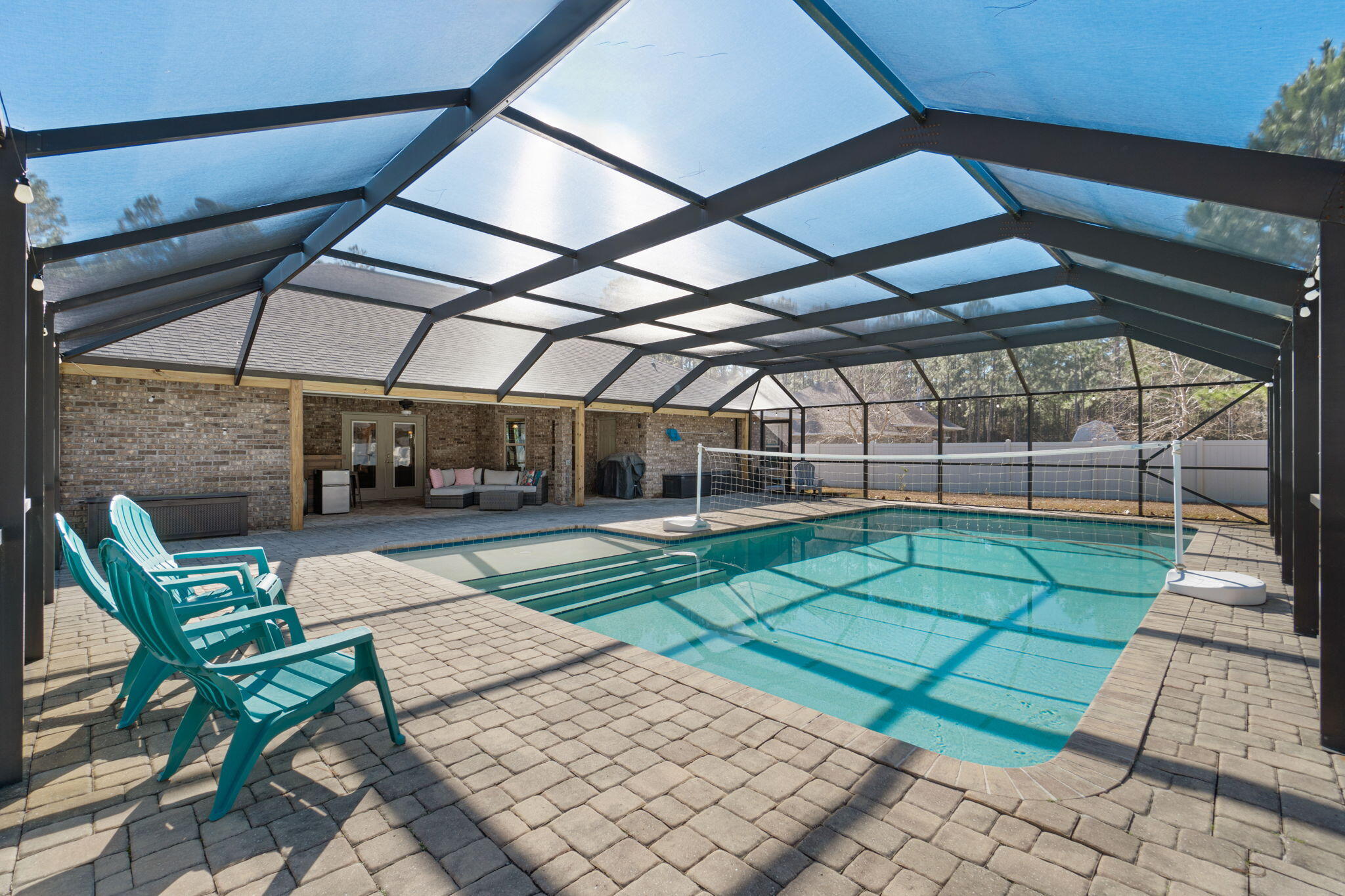 Pool Home with Heated Pool!! Welcome home to this beautifully maintained 4-bedroom, 3-bath pool home with a massive office and a 3-car garage, offering 3,270 sq ft of thoughtfully designed living space in the highly sought-after Holley by the Sea (HBTS) community, just minutes from the white-sand Navarre beaches.
This home features a spacious open floor plan with durable LVP flooring throughout the living, family, and dining areas, making it ideal for everyday living and entertaining. The chef's kitchen is a standout, complete with GE stainless steel appliances, a double oven, granite countertops, a wraparound breakfast bar, a center island, and abundant cabinetry, perfect for hosting holiday feasts or casual gatherings. The family room adds warmth and character with a wood-burning fireplace for those cold nights. 

The expansive primary suite showcases tray ceilings and private access to the backyard oasis. The en-suite bathroom includes a custom tiled shower, soaking tub, and dual vanities. All closets and the pantry feature built-in organizational systems, providing exceptional storage throughout the home. The oversized office offers an ideal space for remote work, a home business, or flexible living needs.

Step outside to your private retreat featuring a screened-in, heated saltwater pool (18x36) with tanning ledge, surrounded by a beautiful paver pool deck, perfect for year-round enjoyment. The backyard also includes some fruit trees and a raised garden, a 20x16 workshop with power, and added peace of mind with a whole-home 60Hz Generac propane generator.

The 3-car garage adds exceptional functionality, with the third bay heated and cooled, ideal for a home gym, workshop, or specialty vehicle storage, and is pre-wired for EV charging. Recent updates include new pool cage screens (2025) and a water heater replaced in 2023.

Residents of Holley by the Sea enjoy outstanding amenities including a private beach house, boat launch, pickleball courts, fitness center, and indoor and outdoor pools.

This home delivers the Florida lifestyle buyers are searching for, spacious living, thoughtful upgrades, resort-style amenities, and close proximity to Navarre Beach.