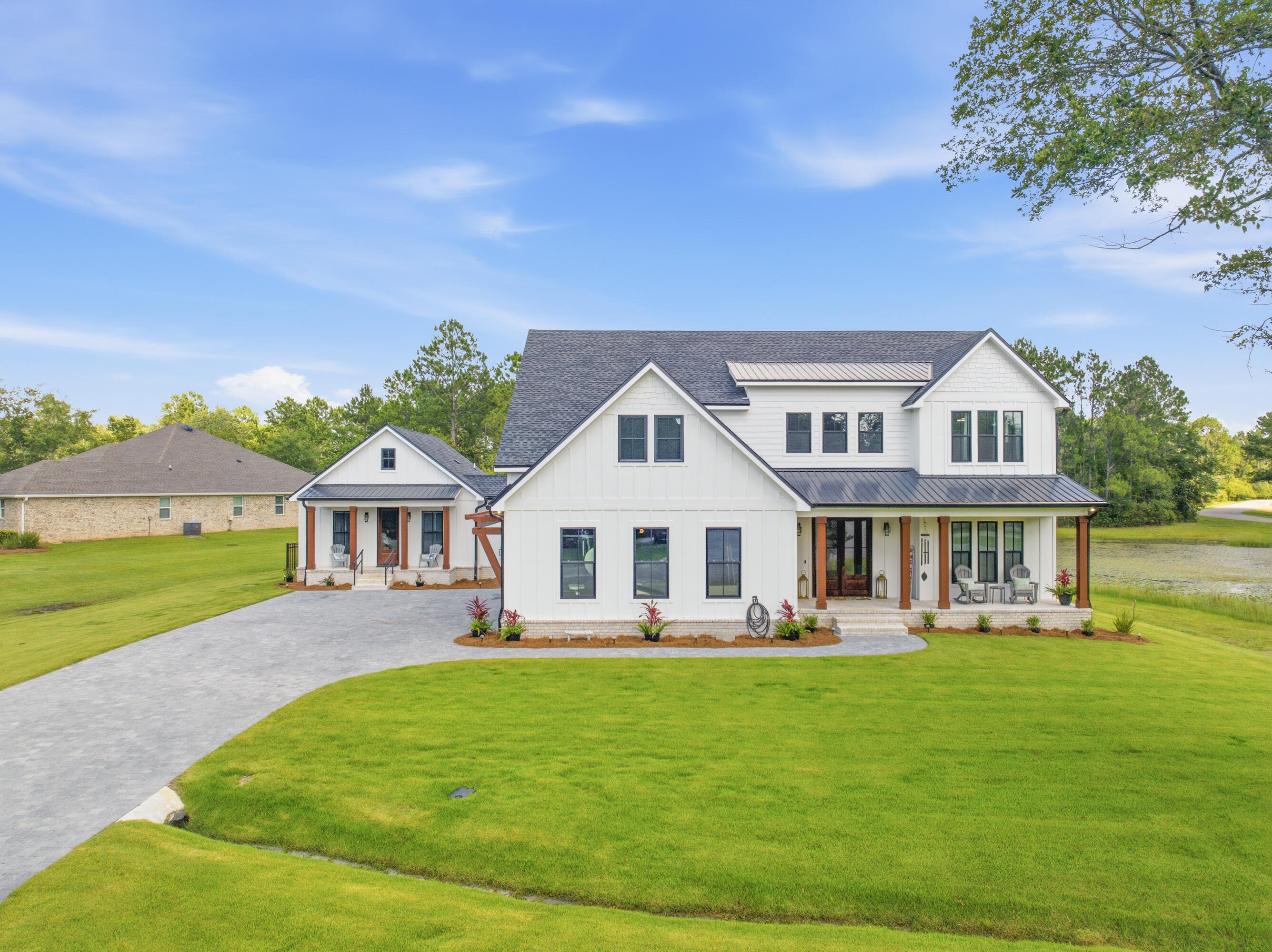 Private access to Choctawhatchee Bay via a dock and boardwalk, RV and boat storage, and expansive nature preserve areas combine to create a lifestyle rarely found. Instead of rear neighbors, a wooded preserve provides privacy and a peaceful natural setting. Custom built in 2025, the home features a chef's main kitchen with a dramatic waterfall quartz island, custom cabinetry, premium built-in refrigeration, a professional-style gas range with pot filler, and quartz countertops throughout, including all bathrooms. The main-level primary suite offers a freestanding soaking tub, oversized walk-in shower, and custom closet. A dedicated office is also located on the main level. Upstairs, additional bedrooms and a spacious loft/game room with wet bar, beverage/wine refrigerator, and sink provide inviting spaces for family, guests, and entertaining. Connected by a vestibule, the private living wing includes its own living area, full kitchen, bedroom, bathroom, laundry, private entrance, and covered porch. The flexible design is ideal for multigenerational living, extended guests, caregivers, or a private retreat. Additional features include a Generac whole-house generator, fenced backyard, covered front and rear porches, and expansive outdoor living space. Conveniently located near 30A, Destin, shopping, dining, and everyday conveniences. Hardie Board exterior. Stem wall foundation. Low-E impact-rated windows and exterior doors. Energy-efficient construction featuring spray foam attic insulation and upgraded building materials throughout. Brick paver driveway and paver sidewalks. Herringbone brick porches. Zoysia grass. Main-level 9-foot ceilings with a 10-foot coffered living room ceiling featuring wood inlay detail. 8-foot interior doors on the main level. Three HVAC systems (heat pumps). Two tankless water heaters. Custom soft-close cabinetry throughout. Walk-in pantry with custom shelving and a secondary full-size refrigerator. Fireplace with shiplap surround and custom floating shelves. Custom floating shelving in the living room, laundry room, and wet bar area. Custom closet systems in the primary bedroom closet and two upstairs bedroom closets. Deep-well irrigation system.