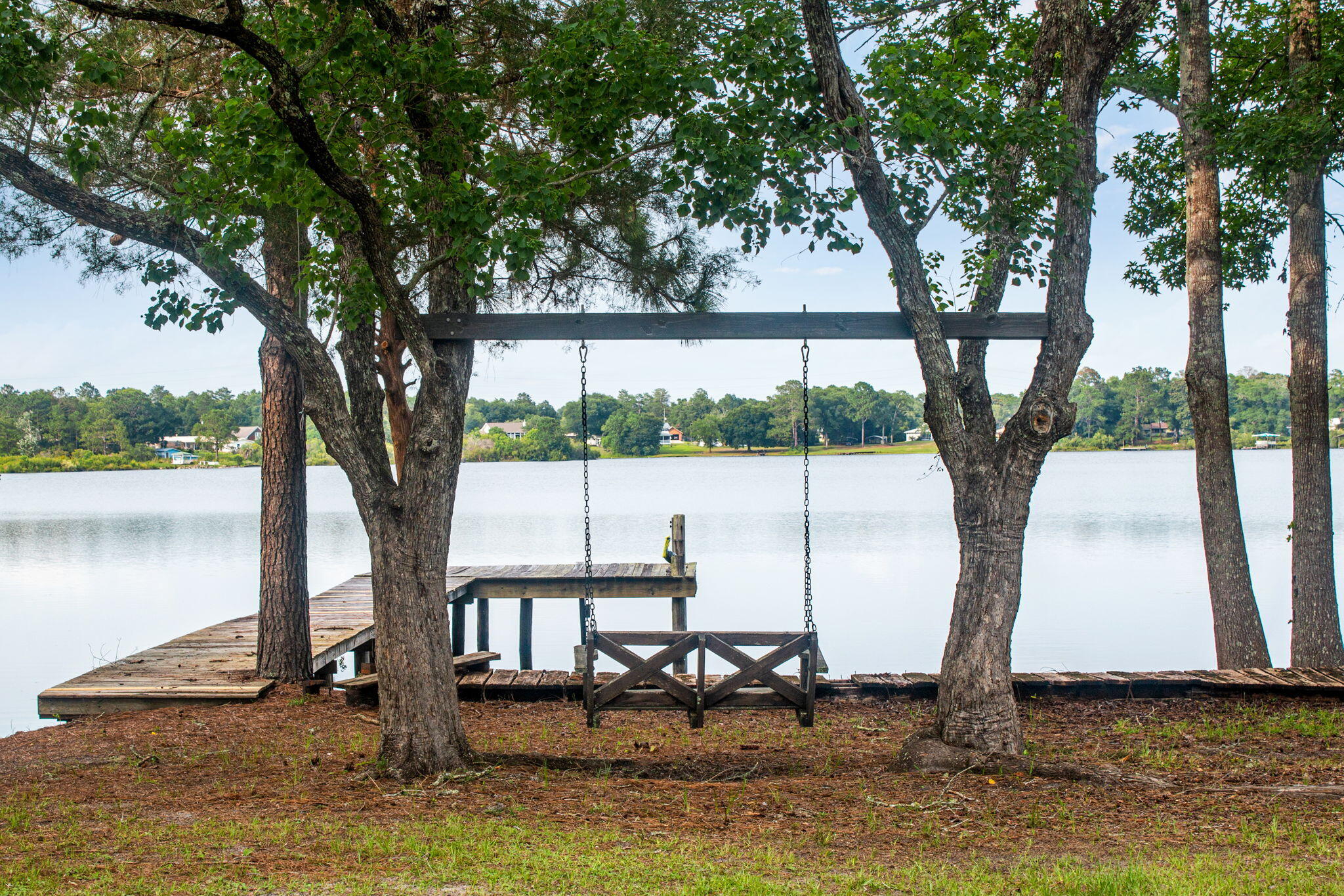 Welcome to your own waterfront retreat on the shores of Lake Stanley, one of DeFuniak Springs' most sought-after spring-fed ski lakes. Surrounded by mature shade trees, this beautifully updated home blends timeless character with modern comforts, offering the perfect setting for full-time living or a weekend getaway.

Inside, you'll find warm hardwood floors, an inviting living room with a cozy fireplace flanked by built-in shelving, and a thoughtfully renovated kitchen featuring butcher block countertops, custom cabinetry, stainless steel appliances, and charming beadboard ceilings. The spacious primary suite offers a peaceful escape with a walk-in closet, barn doors, and an updated en-suite bath, while additional bedrooms provide plenty of room for family and guests.

Step outside to enjoy the expansive multi-level deck overlooking the lake--ideal for grilling, entertaining, or simply relaxing while taking in the peaceful water views. Wander down to your private dock, where endless days of boating, jet skiing, paddleboarding, kayaking, fishing, and swimming await. The gentle shoreline and calm, spring-fed waters create the perfect backdrop for making lifelong memories on the lake. Whether you're watching the sunrise over the water with your morning coffee, spending afternoons on the boat, or enjoying evenings around the fire after a day on the lake, this property offers the waterfront lifestyle you've been dreaming of.

Don't miss your opportunity to own a piece of paradise on Lake Stanley--schedule your private showing today!